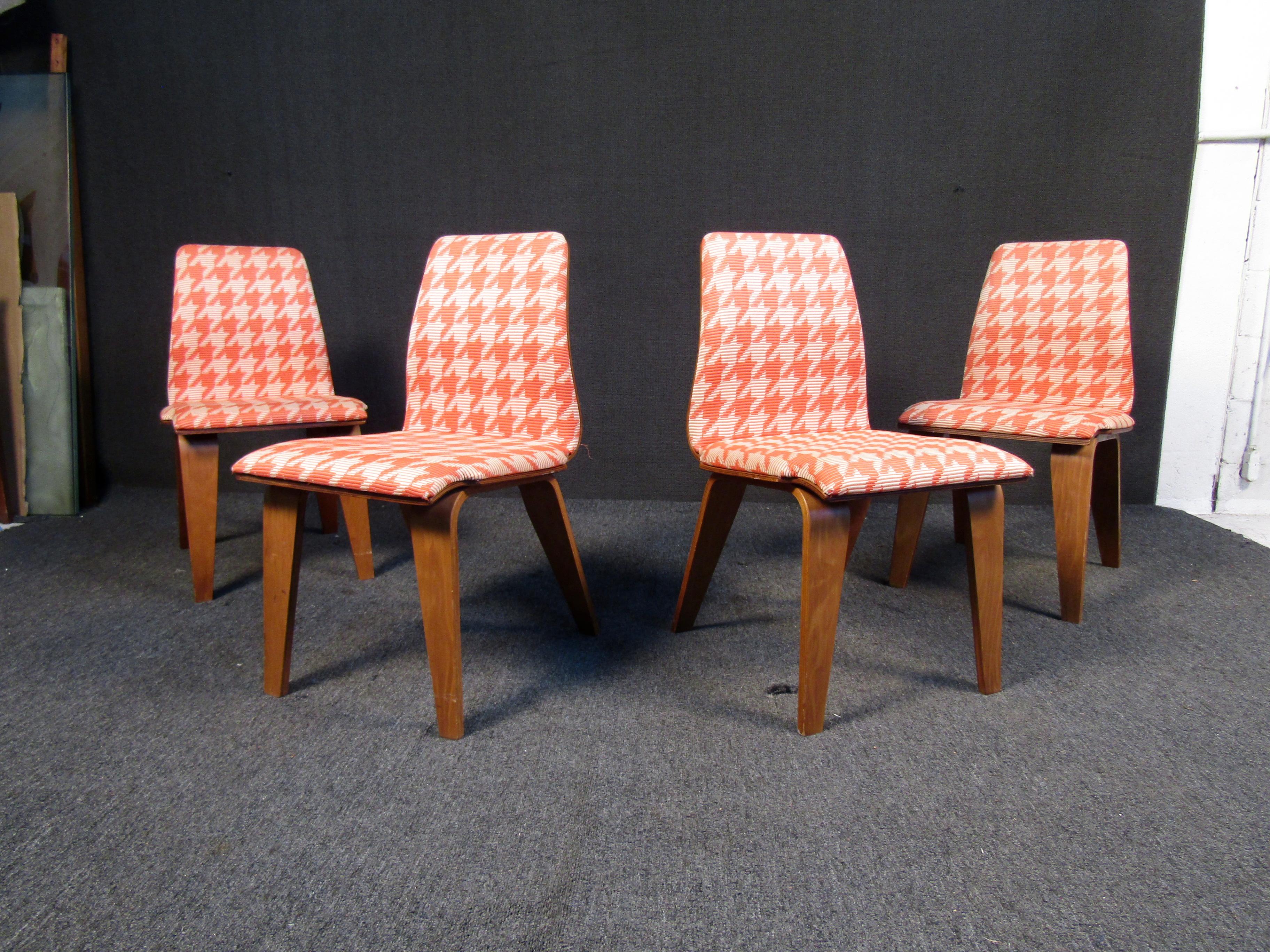 A matching set of four hounds-tooth pattern dining chairs inspired by Knoll. All chairs feature are padded and upholstered with the iconic design as well as a bentwood construction. These classic chairs will add mid century flare to any living or
