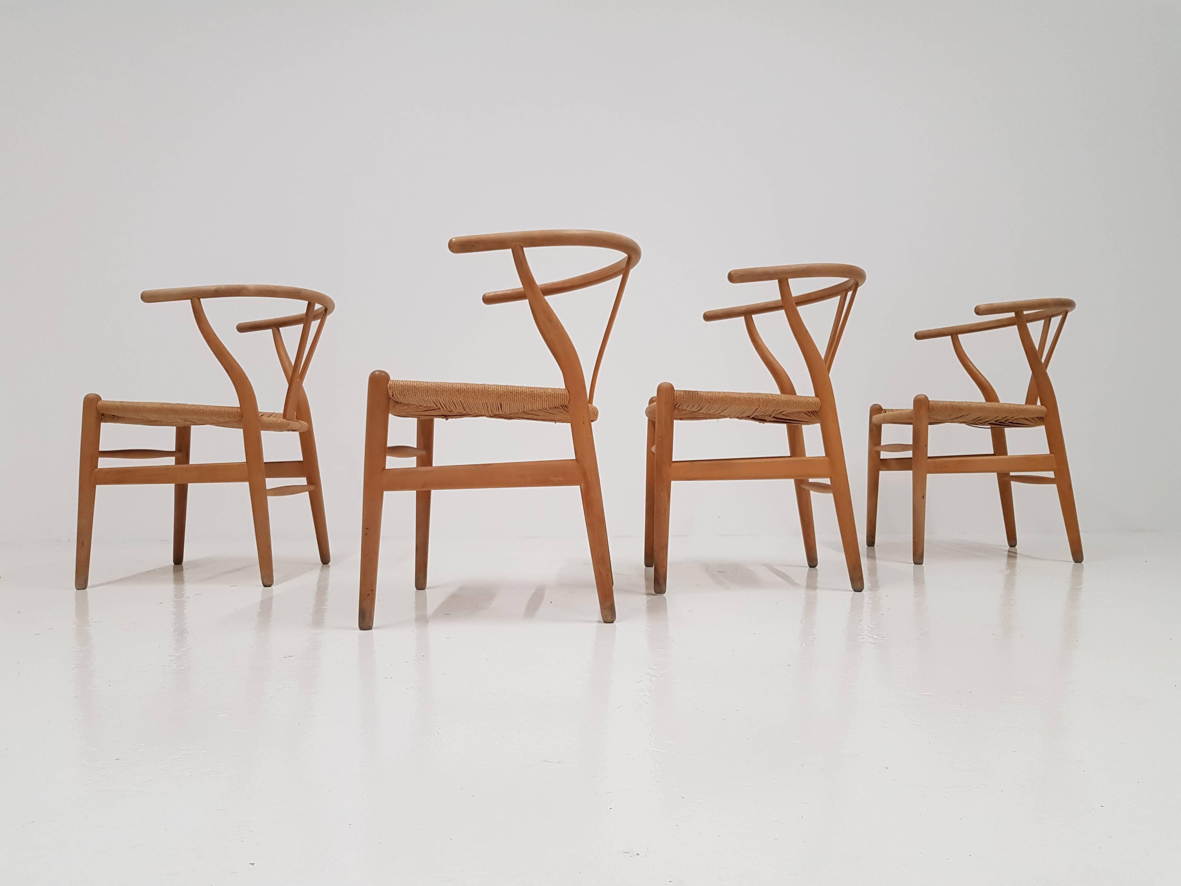 One of the most iconic Danish chairs, Hans J Wegner's CH24 'Wishbone' chairs.

Beech frame and woven paper cord seat. Produced by Carl Hansen & Søn.

General signs of wear, marks on legs, odd staining to paper cord but nothing that isn't