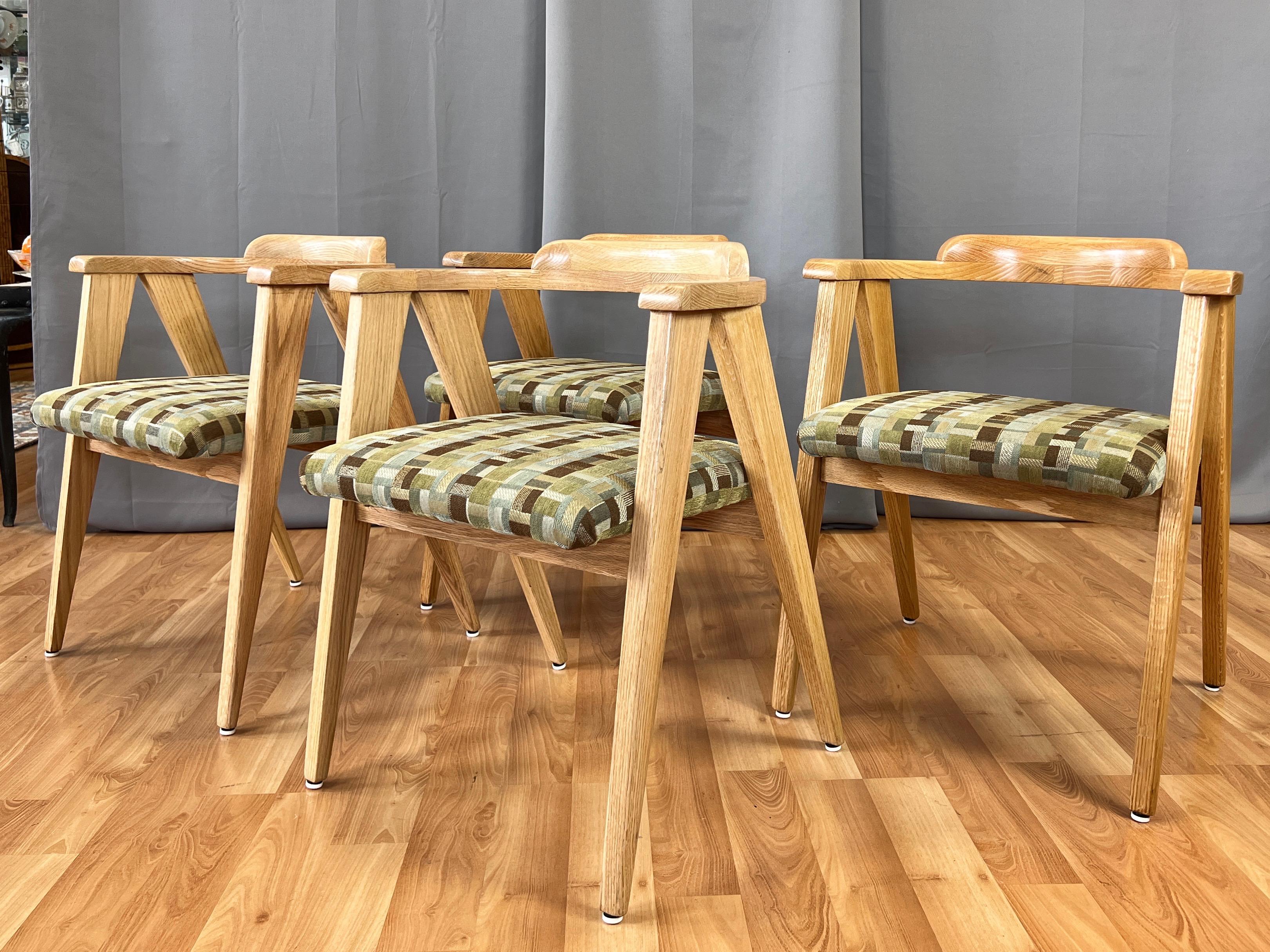An early 1950s four-piece set of mid-century modern live oak compass leg upholstered dining chairs by Indiana Chair Company.

Frames of solid live oak with substantial compass legs and cantilevered half-circle back. A very handsome design from every