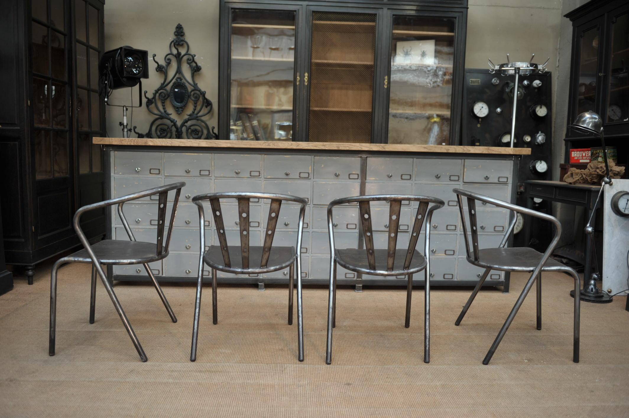 Set of four stackable industrial iron chairs, circa 1950.