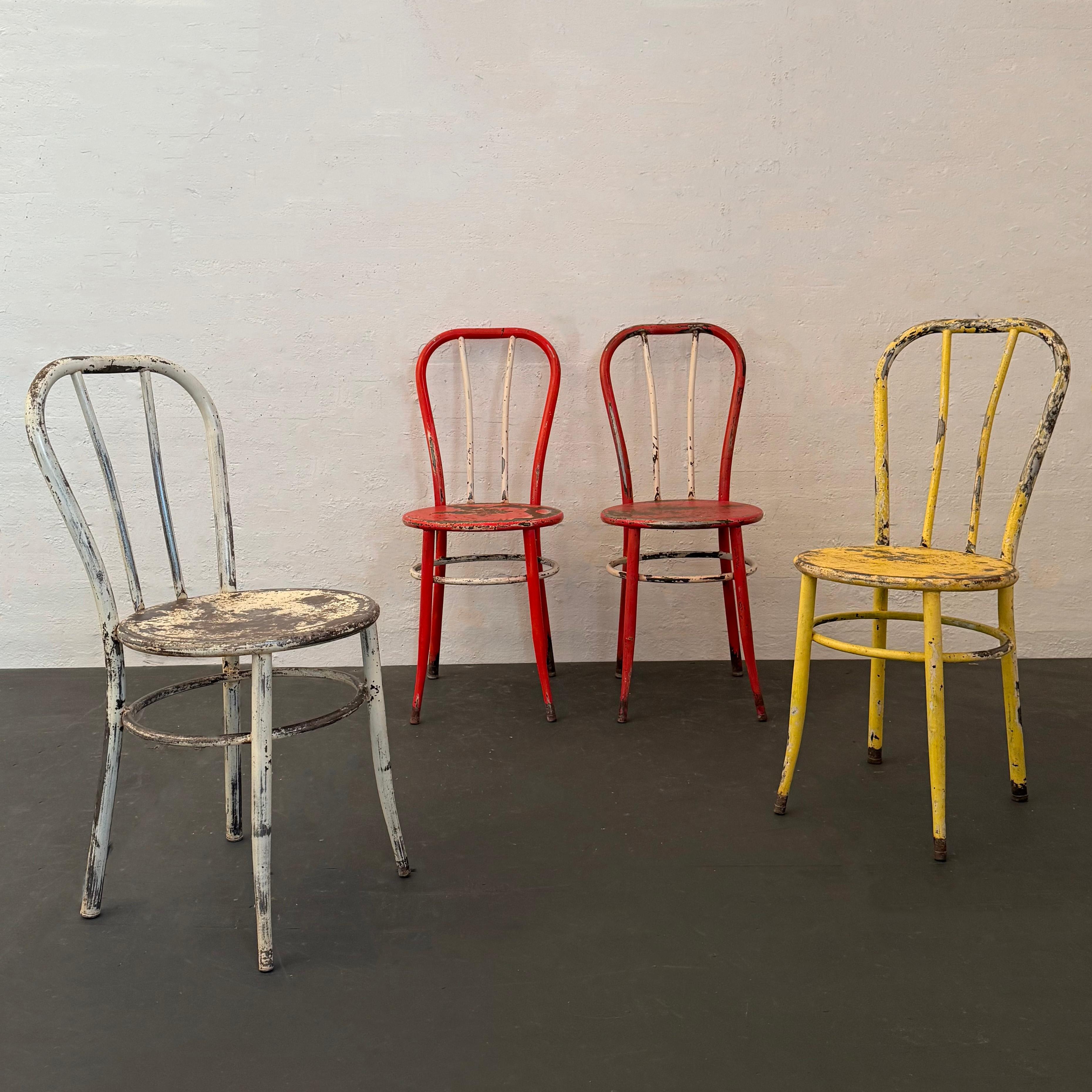 This is a set of four vintage American bent tubular steel café dining chairs. Each chair is lightweight and comprised of cold rolled 