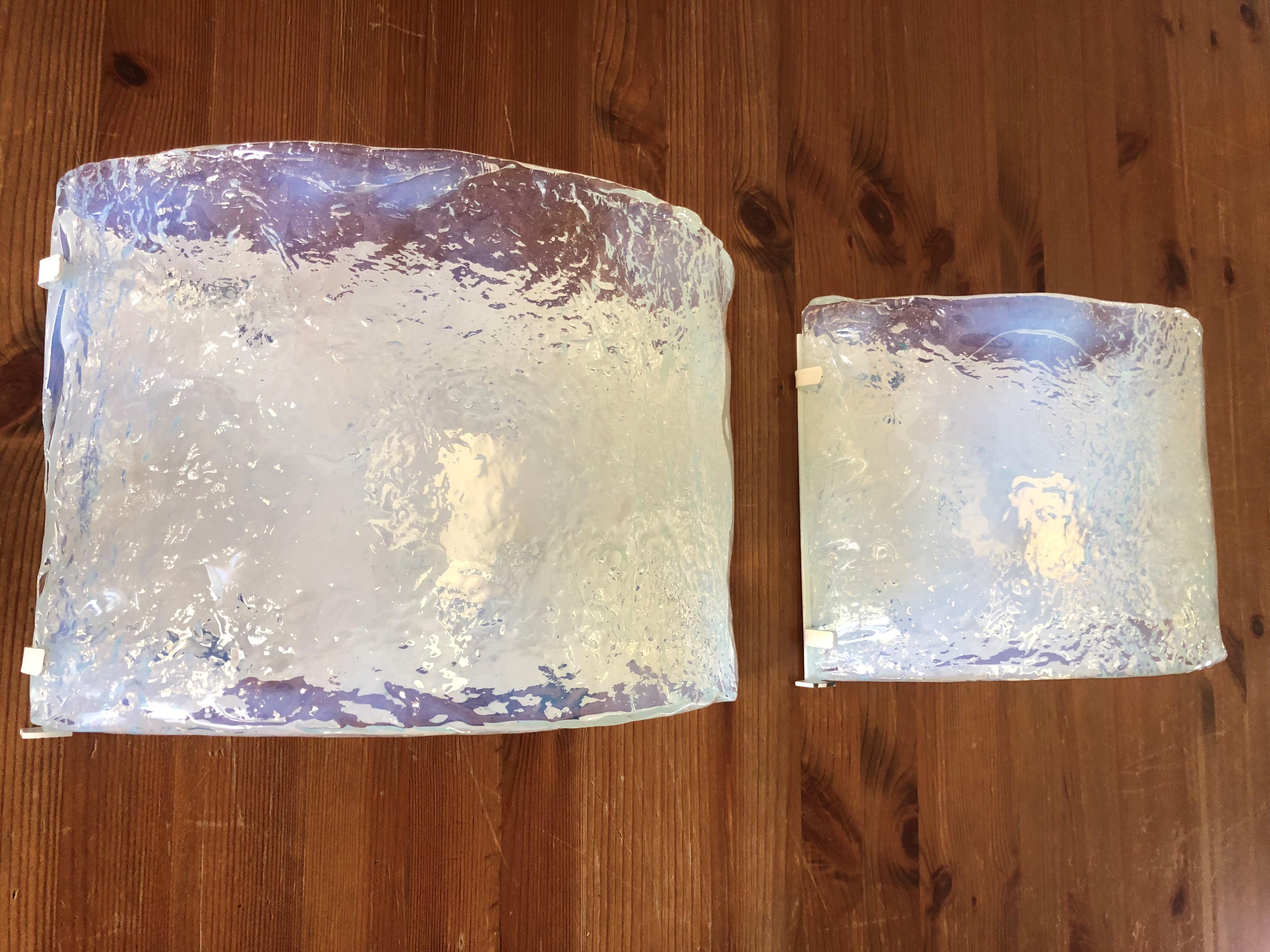 Cool and unique Set of Italian Iridescent Murano glass Wall Sconces from 1970s by Carlo Nason. These Sconces were made during the 1970s in Italy for the Venice Company “A.V .Mazzega”.
“A.V Mazzega” original sticker label still shows on the murano