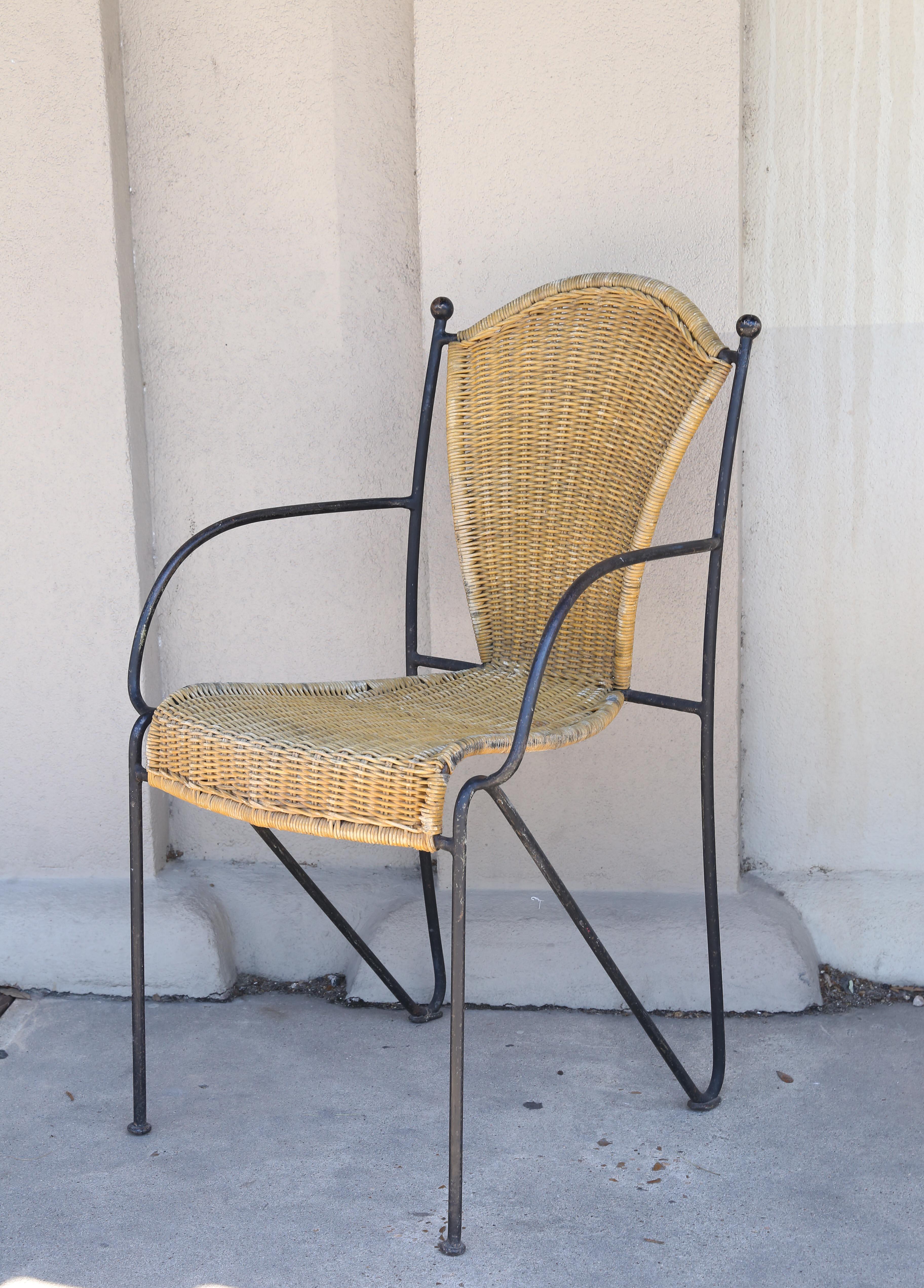 Set of four very stylish and also stackable iron and wicker chairs found in France. Each chair has a wicker seat and back, in a golden tone. Very little staining, but there is some age to the material. These chairs are all in similar condition and