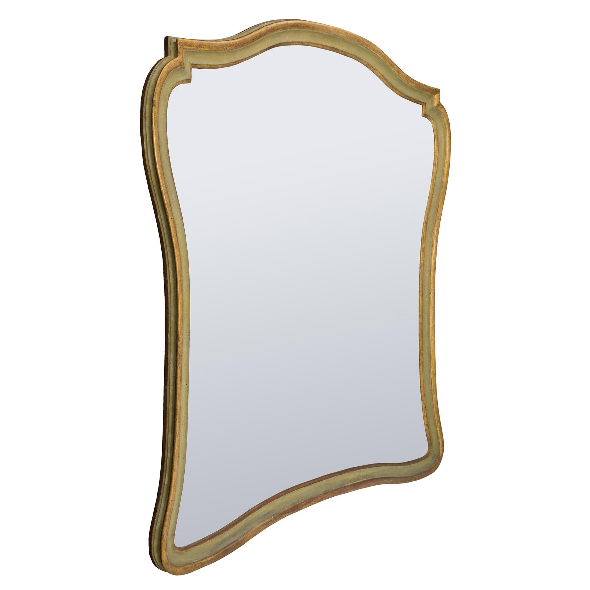 A beautiful and unique complete set of four Italian 18th century Genovese mecca and patinated mirrors. Each large scale mirror plate is framed within an elegant and most decorative lightly curved mottled frame. The frame displays a patinated green