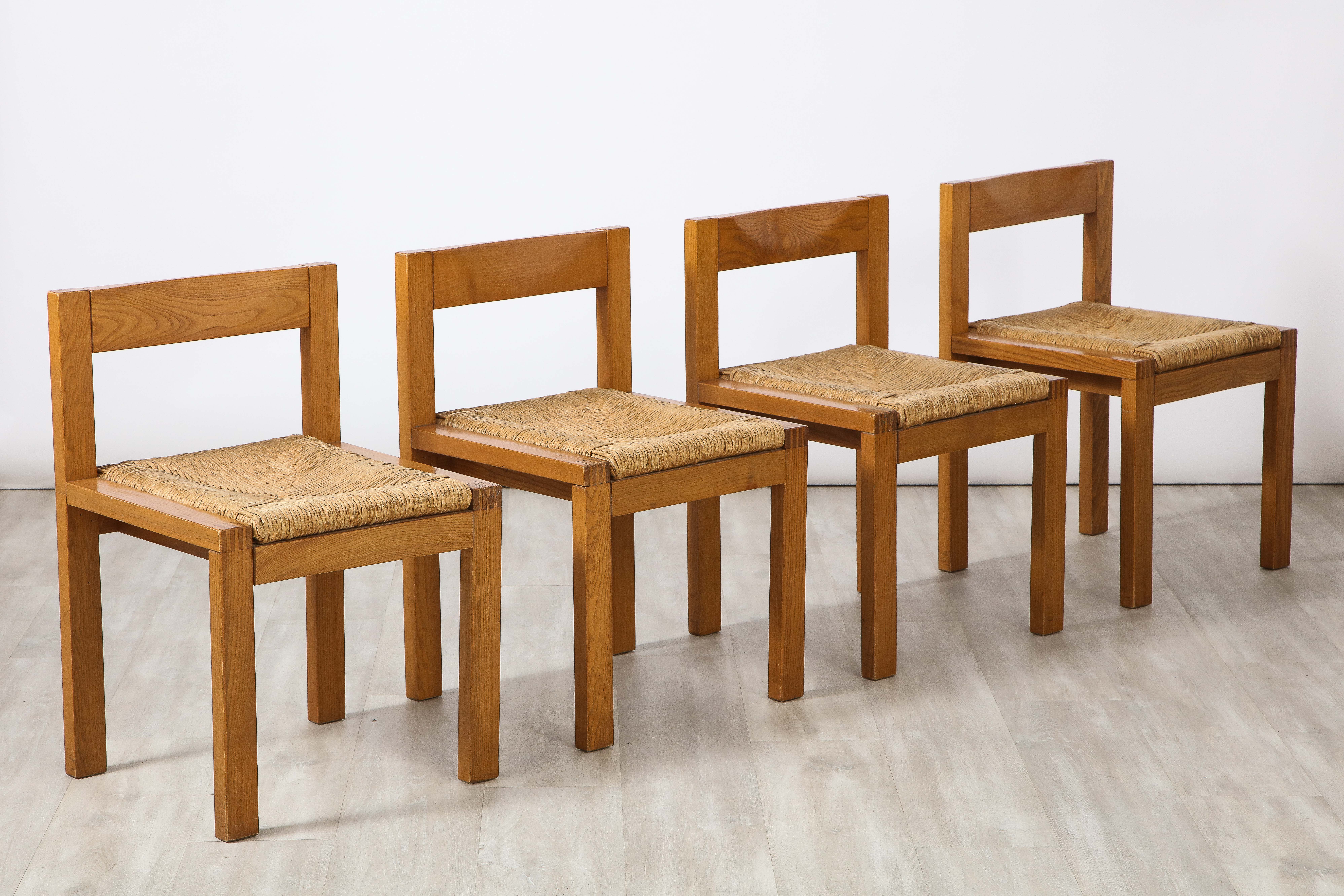 A charming set of four Italian rustic oak and rush seat dining chairs, with horizontal slat open backs.  Simply and beautifully handcrafted with graceful proportions and an organic modern feel.
Italy, circa 1950's
Size: 26 3/4