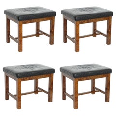 Set of four Italian 1970s classic stools in wood and leather.