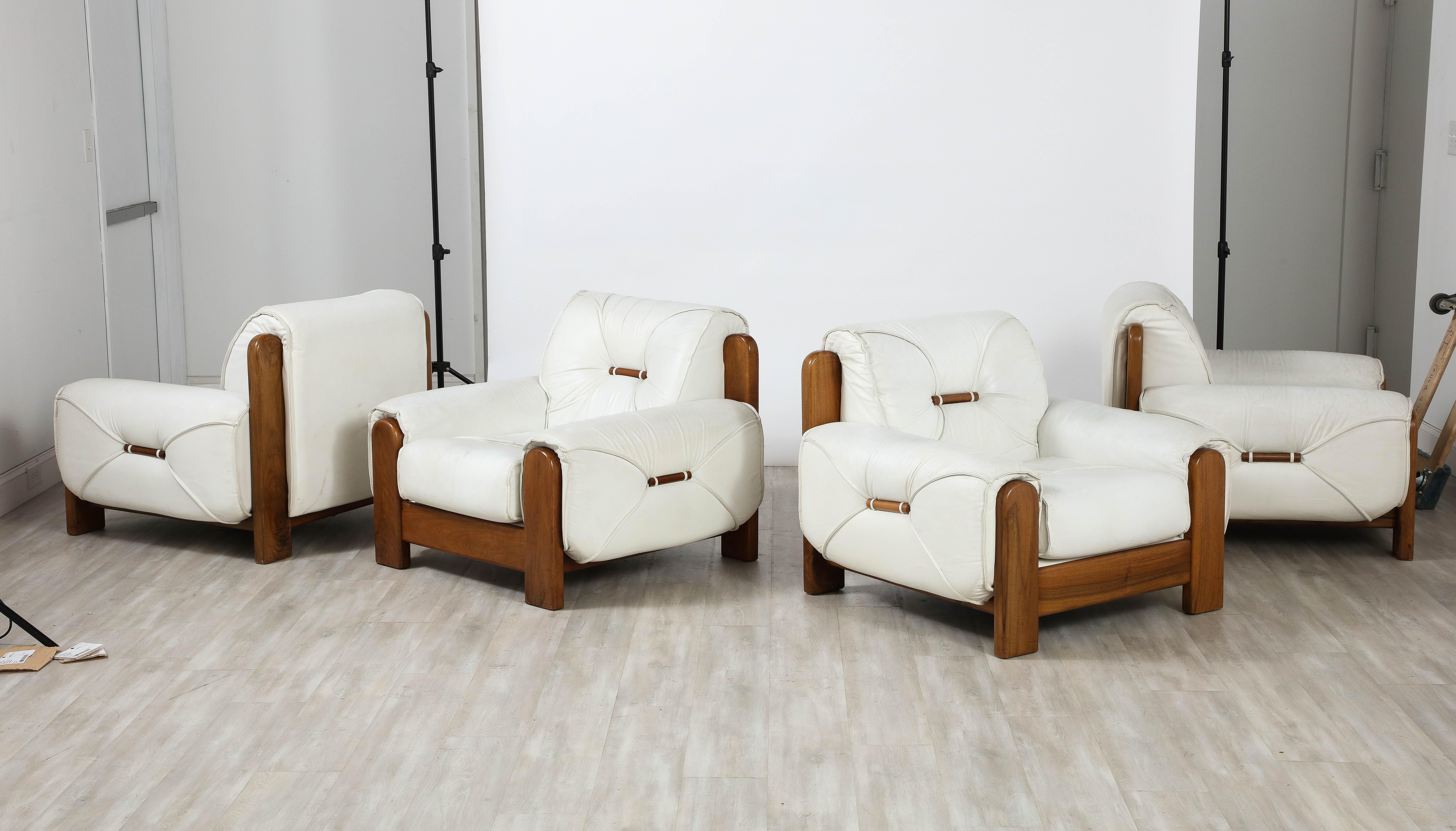 A highly unique and superb set of four Italian 1970's lounge chairs.  Hand-crafted with a nod toward the Brazilian iconic designers of the period, Jean Gillon and Sergio Rodrigues.  The robust walnut frames are a stunning contrast to the original