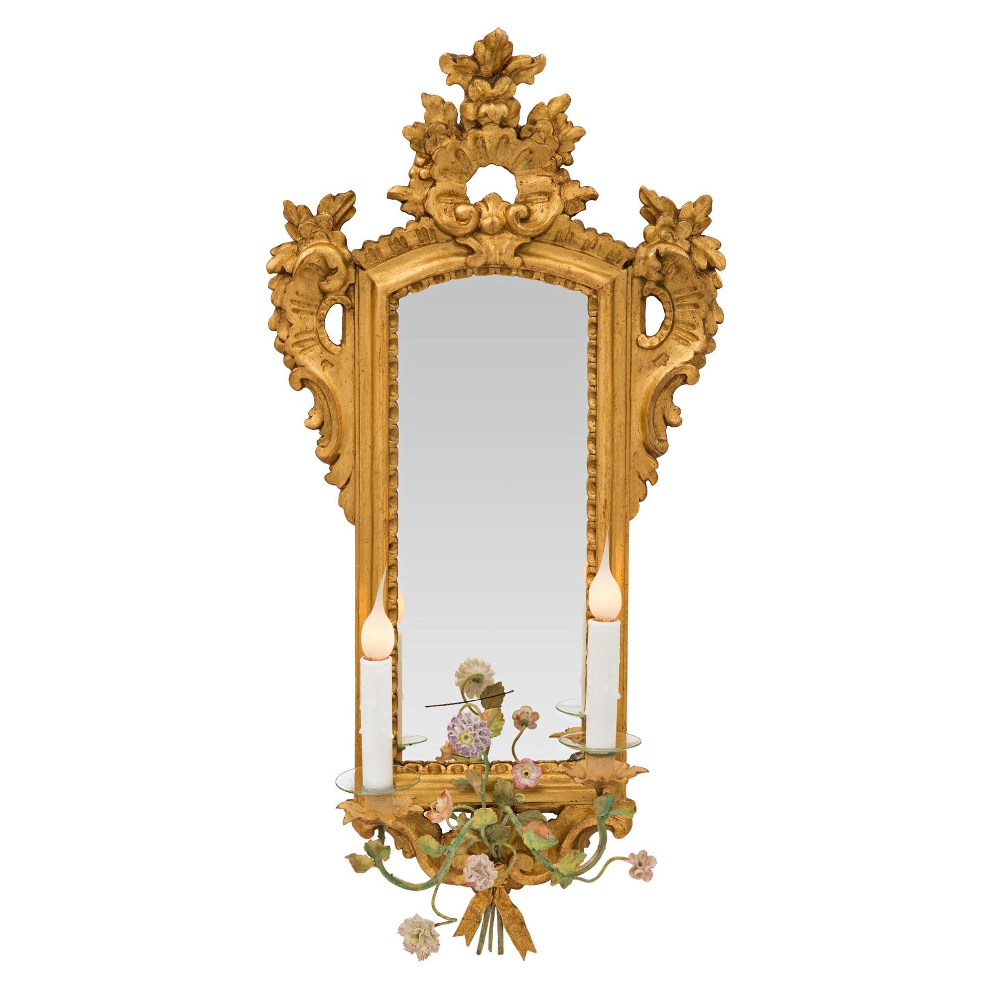 A stunning and most unique set of four Italian early 19th century Louis XV st. giltwood and Saxe porcelain mirrored sconces. Each charming sconce retains its original mirror plate set within an elegant and most decorative mottled frame with a lovely