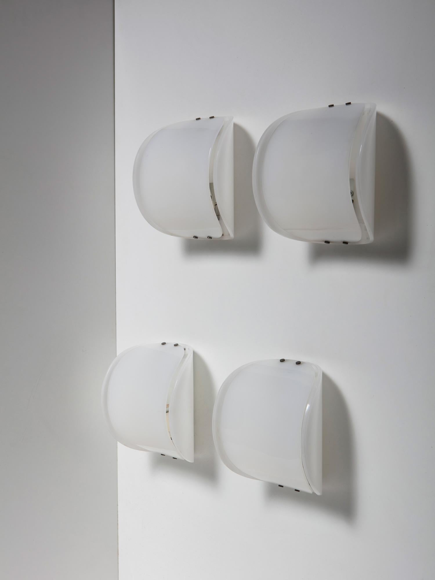 Set of four wall lamps with plexiglass body and metal details.