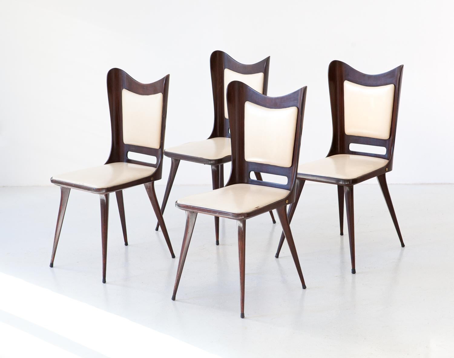 Set of 4 dining chairs manufactured in Italy during the 1950s 

The frame is made of solid and high quality wood.
The original beige skai upholstery is in pur condition. 

We offer the possibility of having new upholstery, in this way you can have