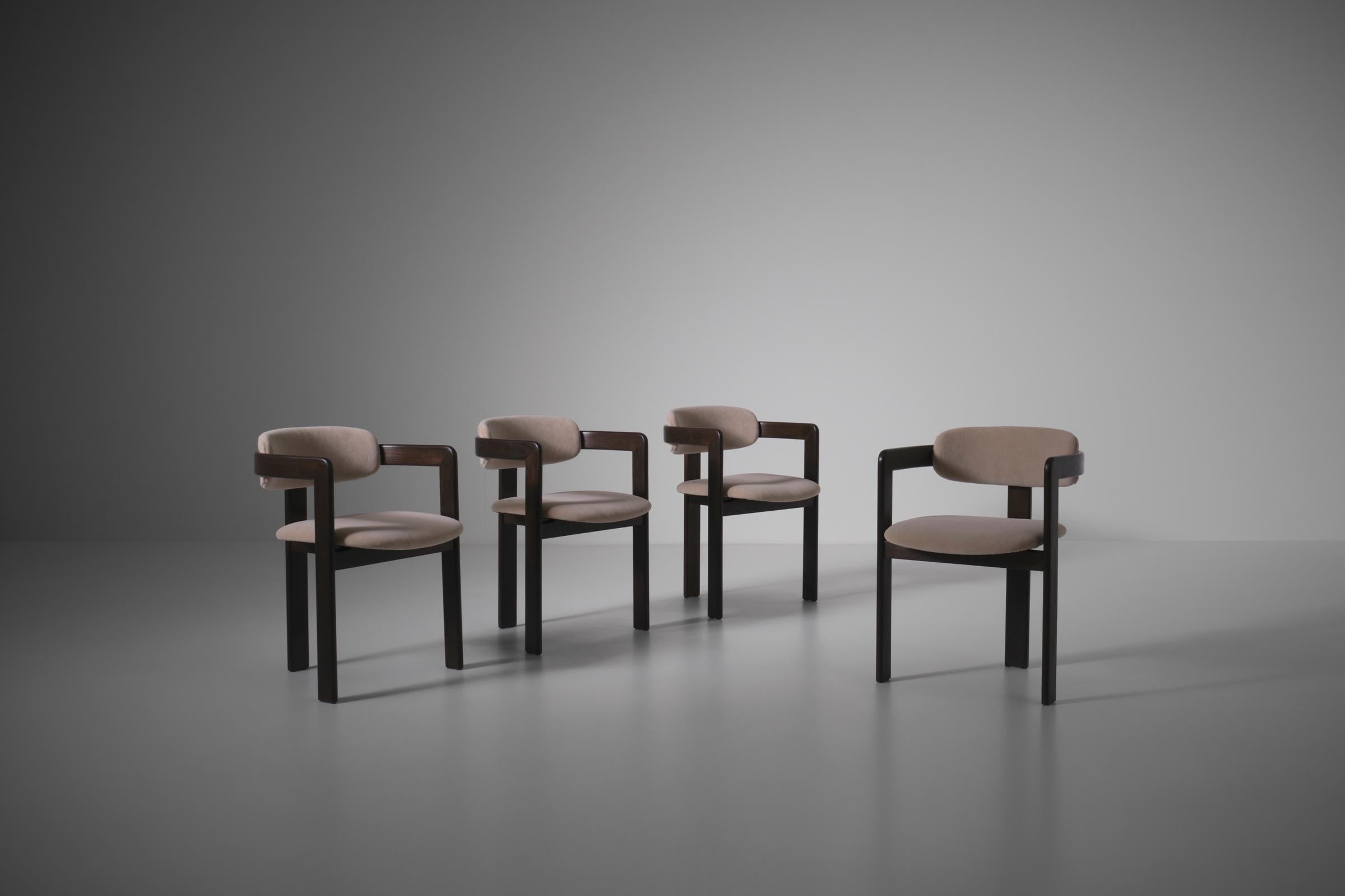 Set of four sculptural dining chairs, Italy 1970s. Beautiful bentwood frames in dark stained ash with a nice contrasting sand colored velvet mohair. The chairs have a strong sculptural design with beautiful details, reminiscent of the Pamplona