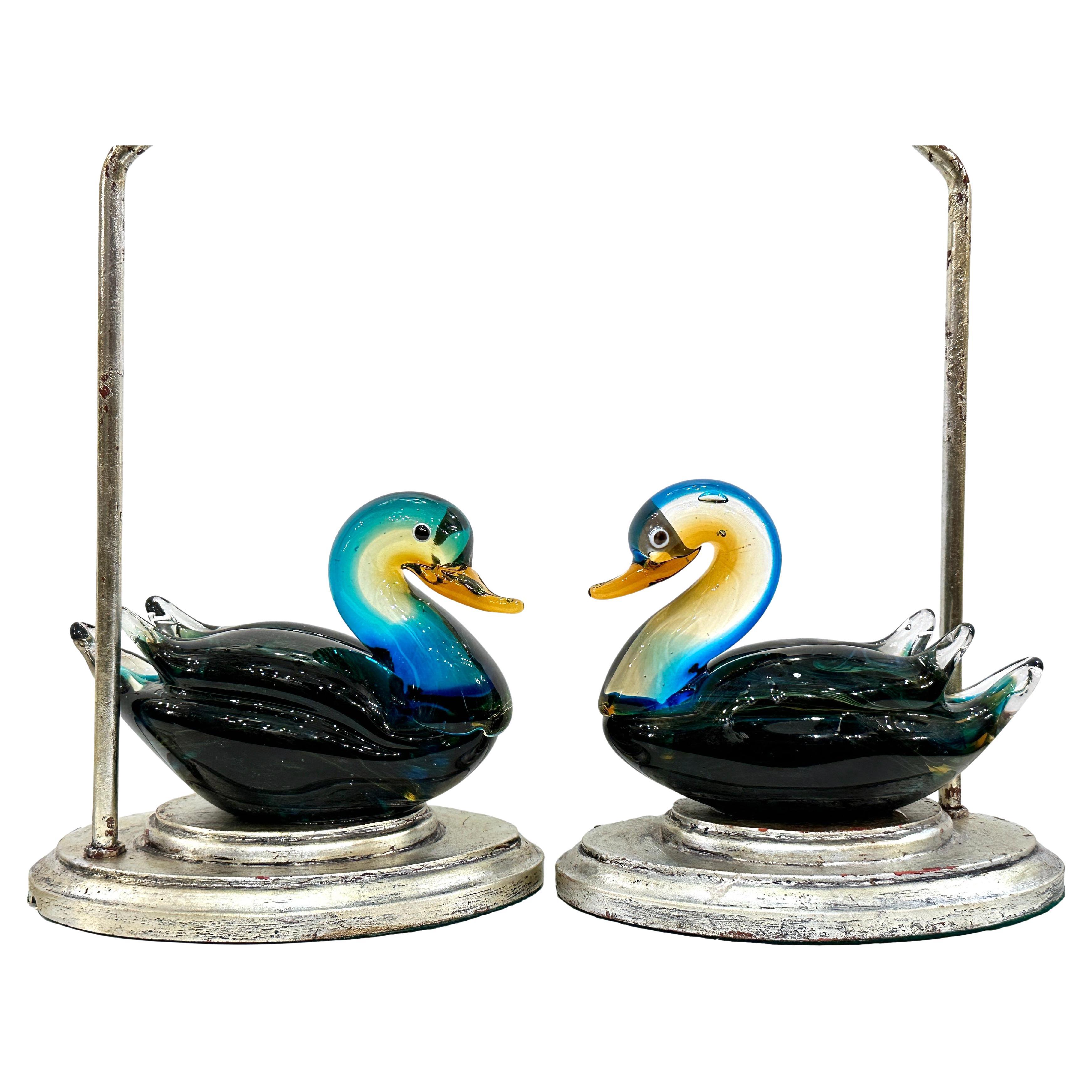 A pair of circa 1950's Italian blown glass ducks mounted as lamps, with silver-leafed bases. 

Measurements:
Height of body: 7
