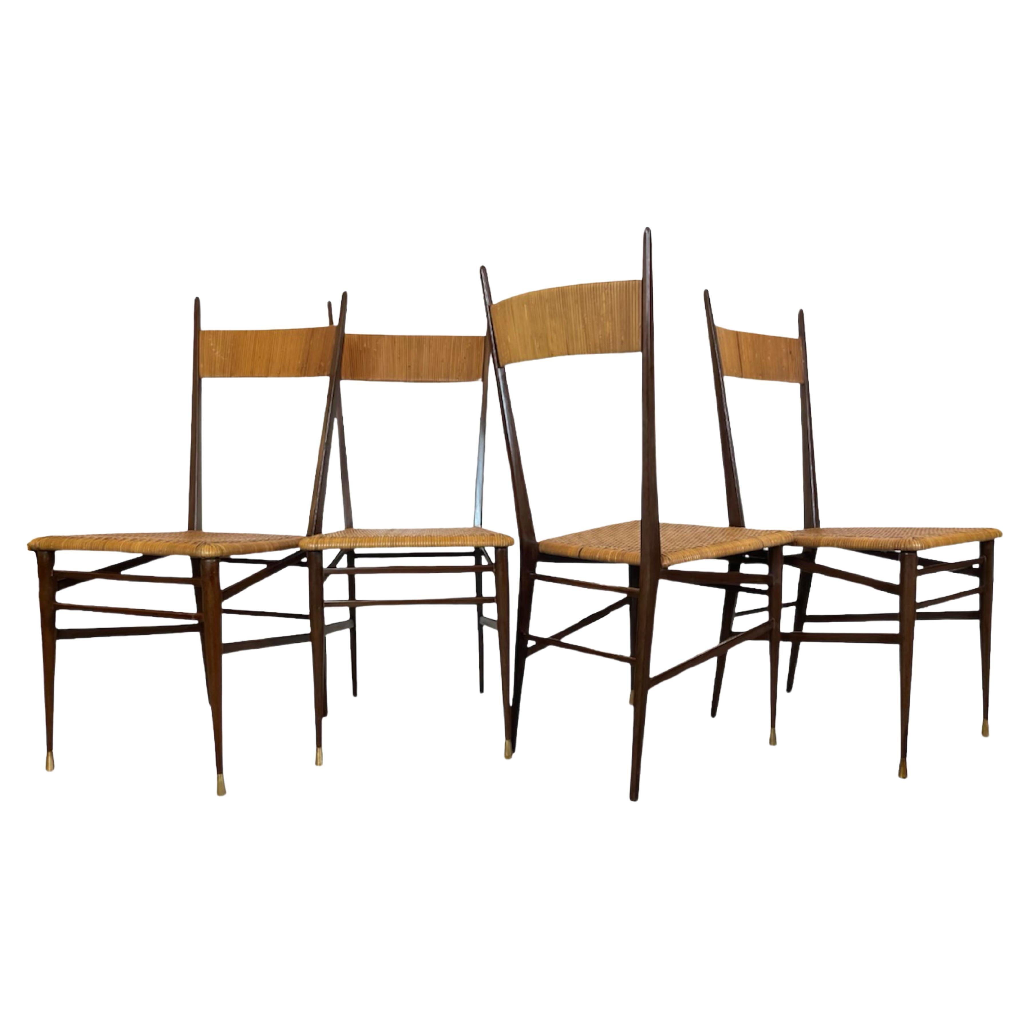 Set of four Italian design chairs, Scuola di Torino, circa 1950s.
4 traditional Italian Chiavari , in the manner of Gio Ponti and Superleggera.
Featuring solid wood frame, with woven rattan seats and backrests. 
Each set of 2 front legs are finished
