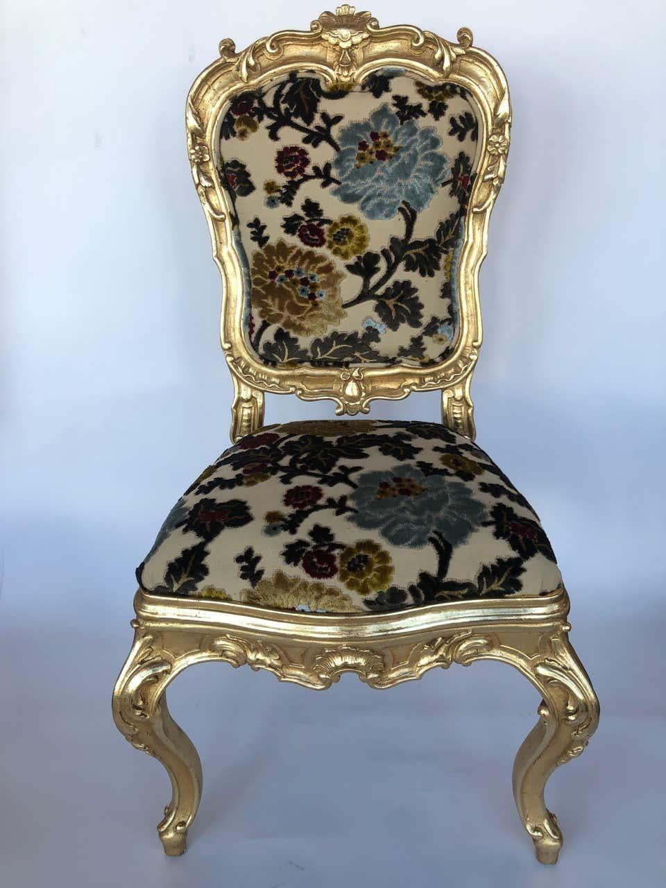 A stunning set of four Italian hand-carved wooden chairs, elegantly finished in 22-karat gold gilding. These exquisite chairs showcase intricate detailing, reflecting the craftsmanship of classic European design. Newly upholstered in a vintage