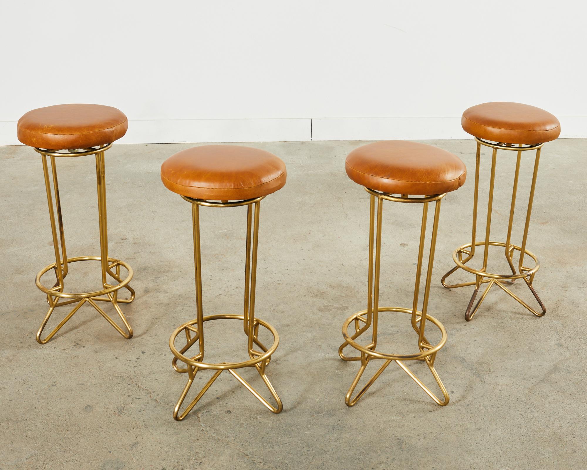 Amazing set of four Italian bronzed iron swivel bar stools made in the manner and style of Ico Parisi and Gio Ponti. Each stool is stamped 