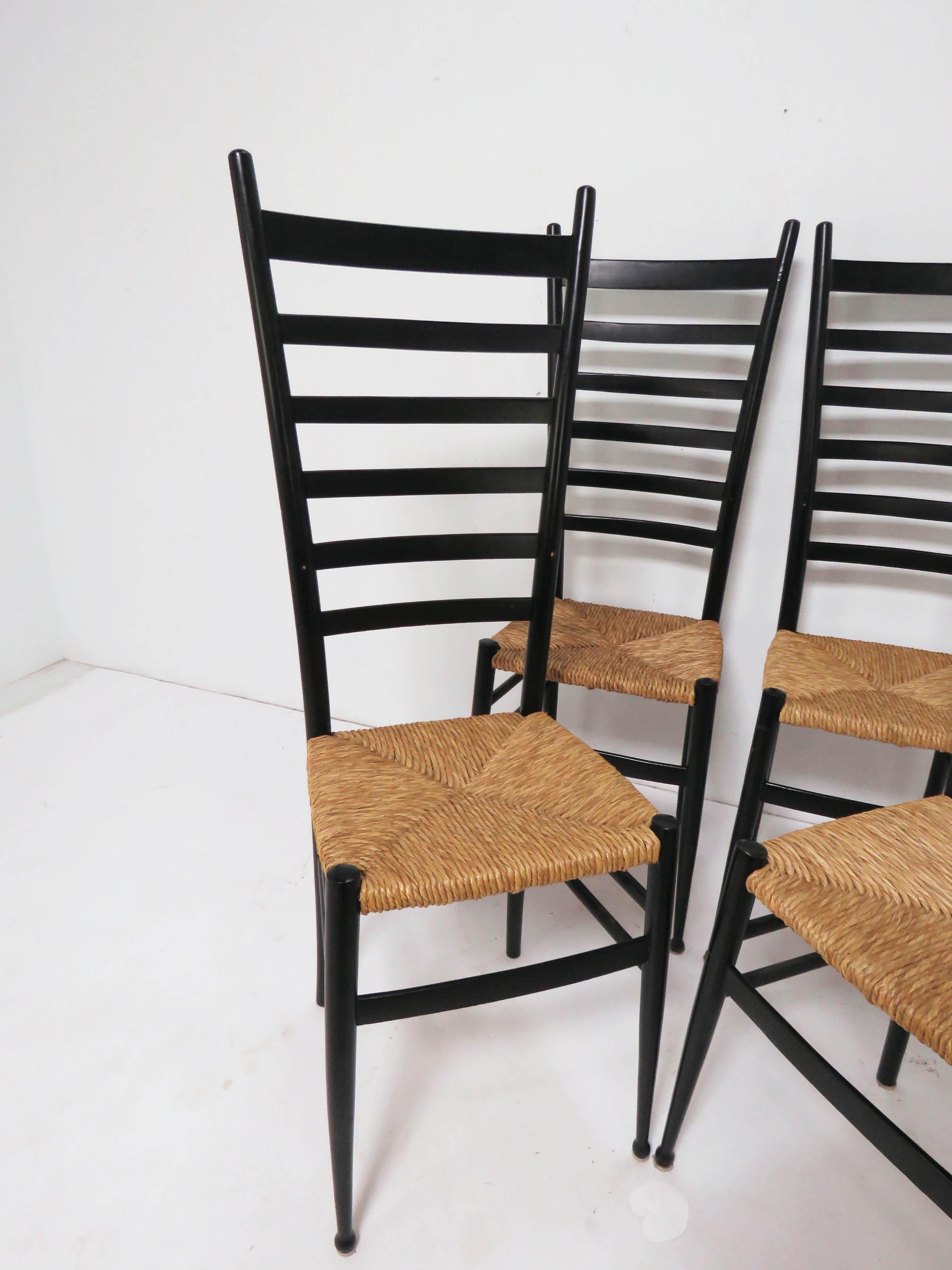 Set of Italian ladder back dining chairs in lacquered wood with woven rush seats in the manner of Gio Ponti, imported in the 1960s from the Chiavari region by Otto Gerdau.