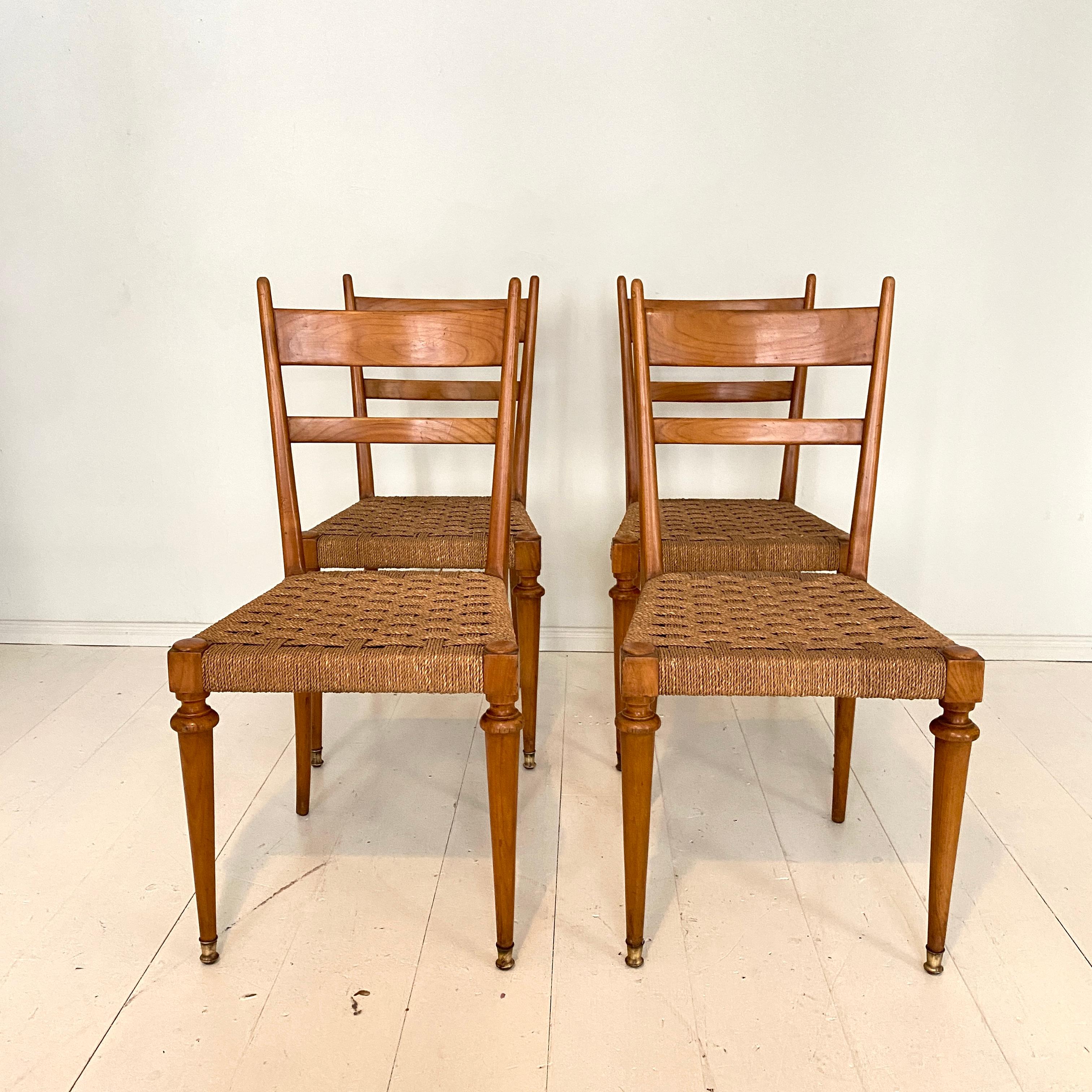 This set of four Italian mid-century dining chairs where probably designed and made by Gugliemo Pecorini in the early 1940s. they are made in solid cherry and handcrafted seat in woven rope.
The turned front legs have a brass shoe ending. With the