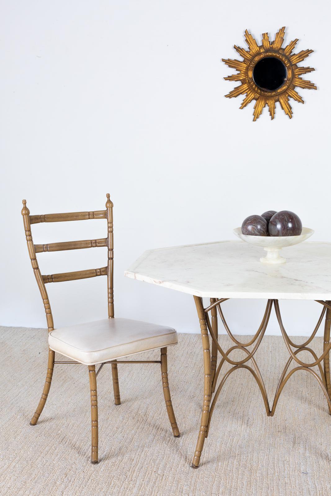 Whimsical set of four Italian Mid-Century Modern dining chairs featuring unique faux bamboo iron frames. Each chair has a ladder back design with splayed legs in the back. The chairs have graceful curves topped with a finial on each side. The iron