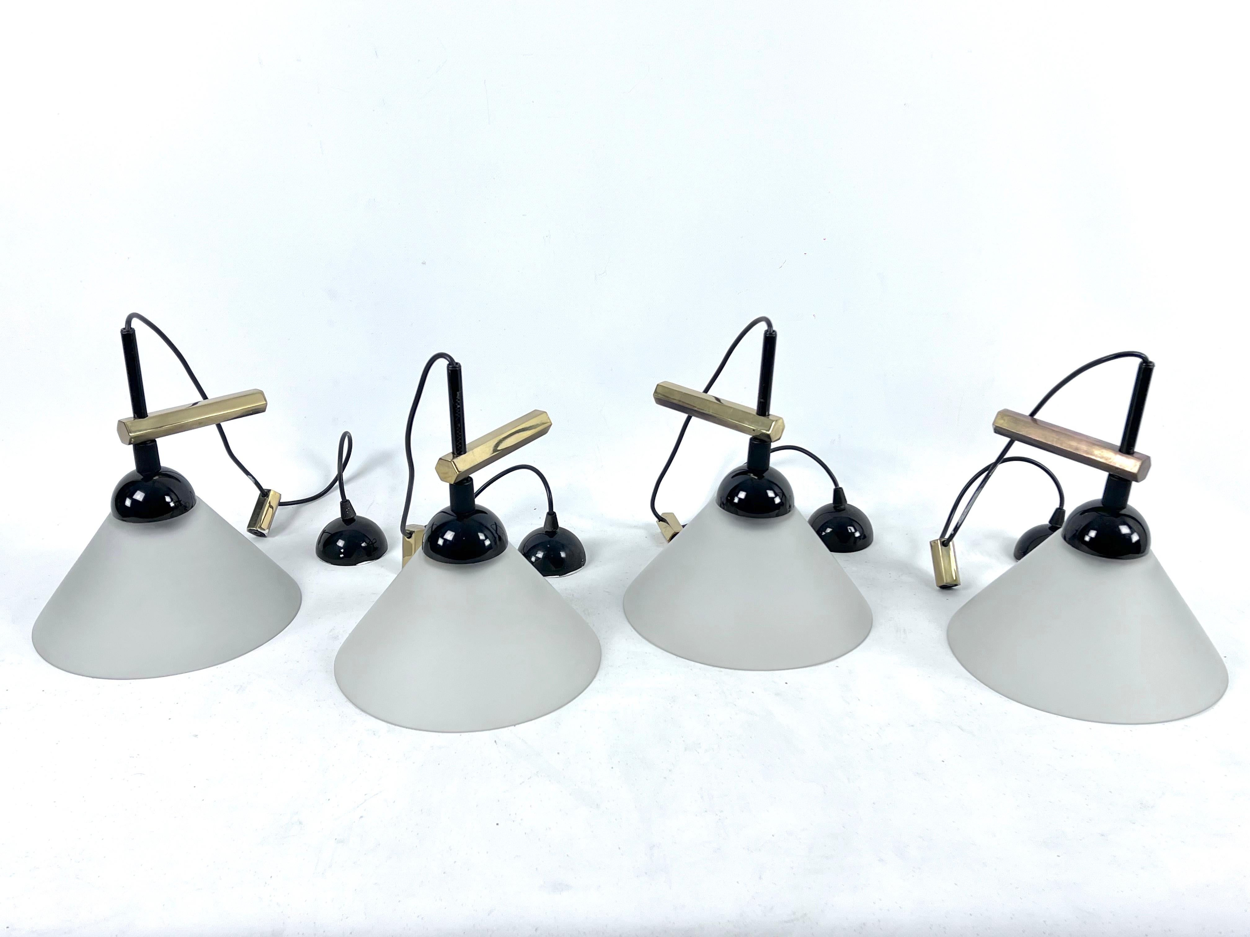 Set of four wall lamps by Quattrifolio. Made from Murano glass shade, solid brass and lacquered metal. Produced in Italy during the 70s. Each sconce mounts a socket for E27 bulb. The lamp is mounted on the wall through the long solid brass bracket,