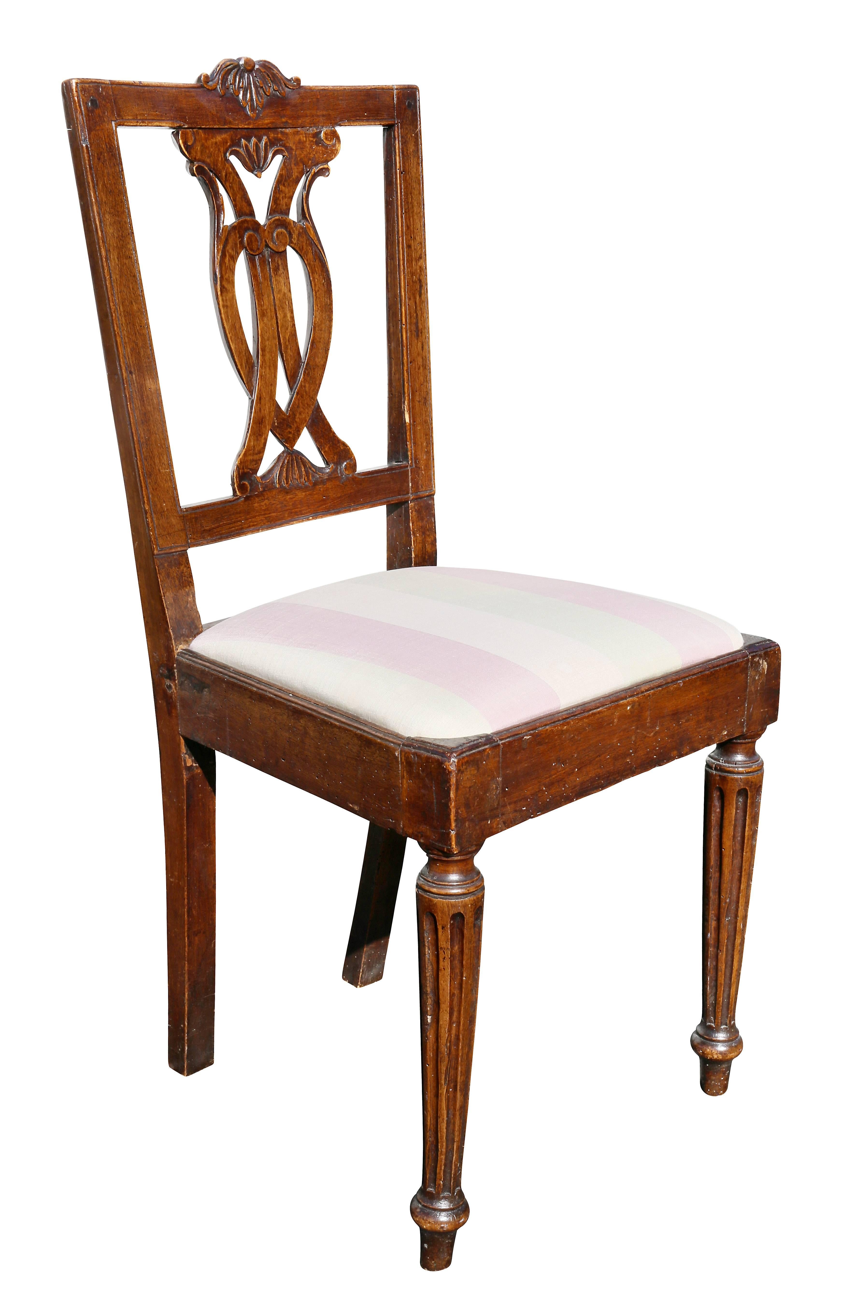 Each with a rectangular back with open splat, drop in seats, raised on circular fluted tapered legs.