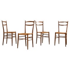 Satz von vier italienischen Esszimmerstühlen aus Nussbaumholz im Paolo Buffa-Stil