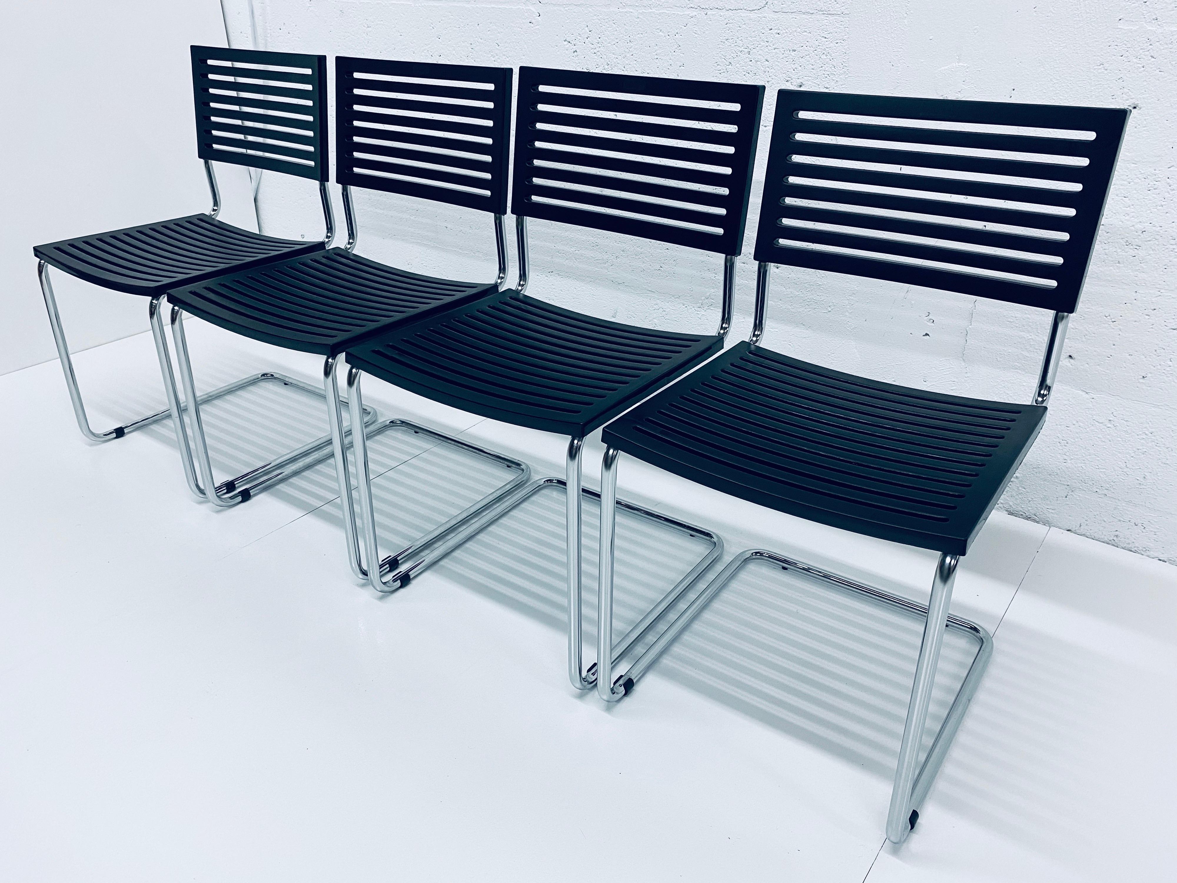 Four Postmodern tubular chrome dining chairs with plastic slat seat and back manufactured in Italy from recycles material. These chairs are a postmodern take on the Bauhaus era designed tubular cantilevered chairs by Mart Stam, circa 1980s.