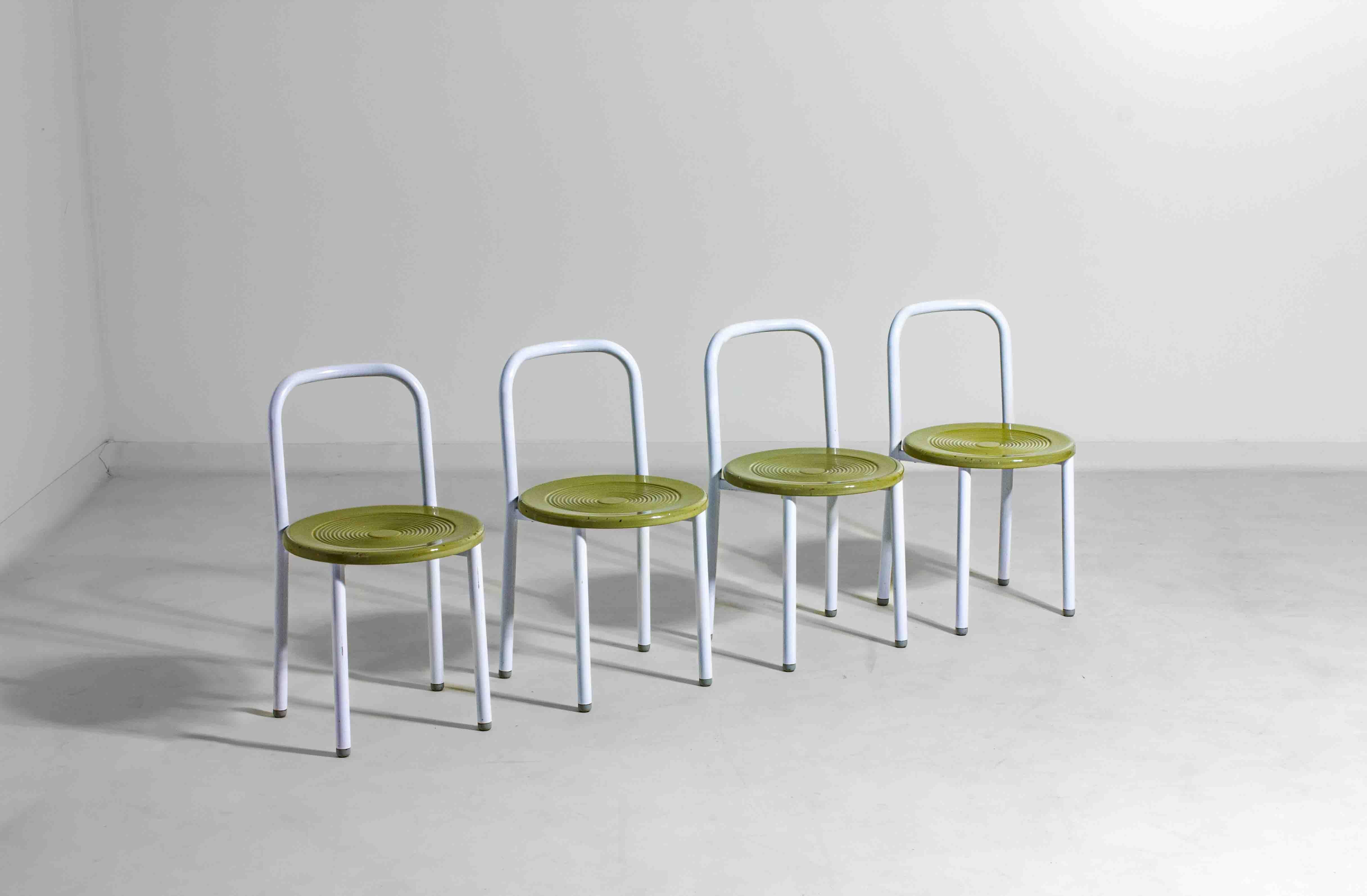 Playful set of four Italian postmodern chairs from the 1980s. Each chair has a white metal tubular frame with a rounded backrest and an eye-catching olive green seat in glossy molded metal, finished with concentric circles for texture and grip

