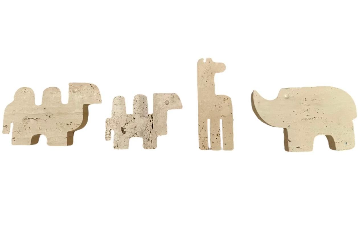 Set of four Italian travertine animal sculptures. Set of four soft line travertine animals in brutalist style consisting of a giraffe, a rhino and two camels, handmade by Fratelli Mannelli. Italy, circa 1970