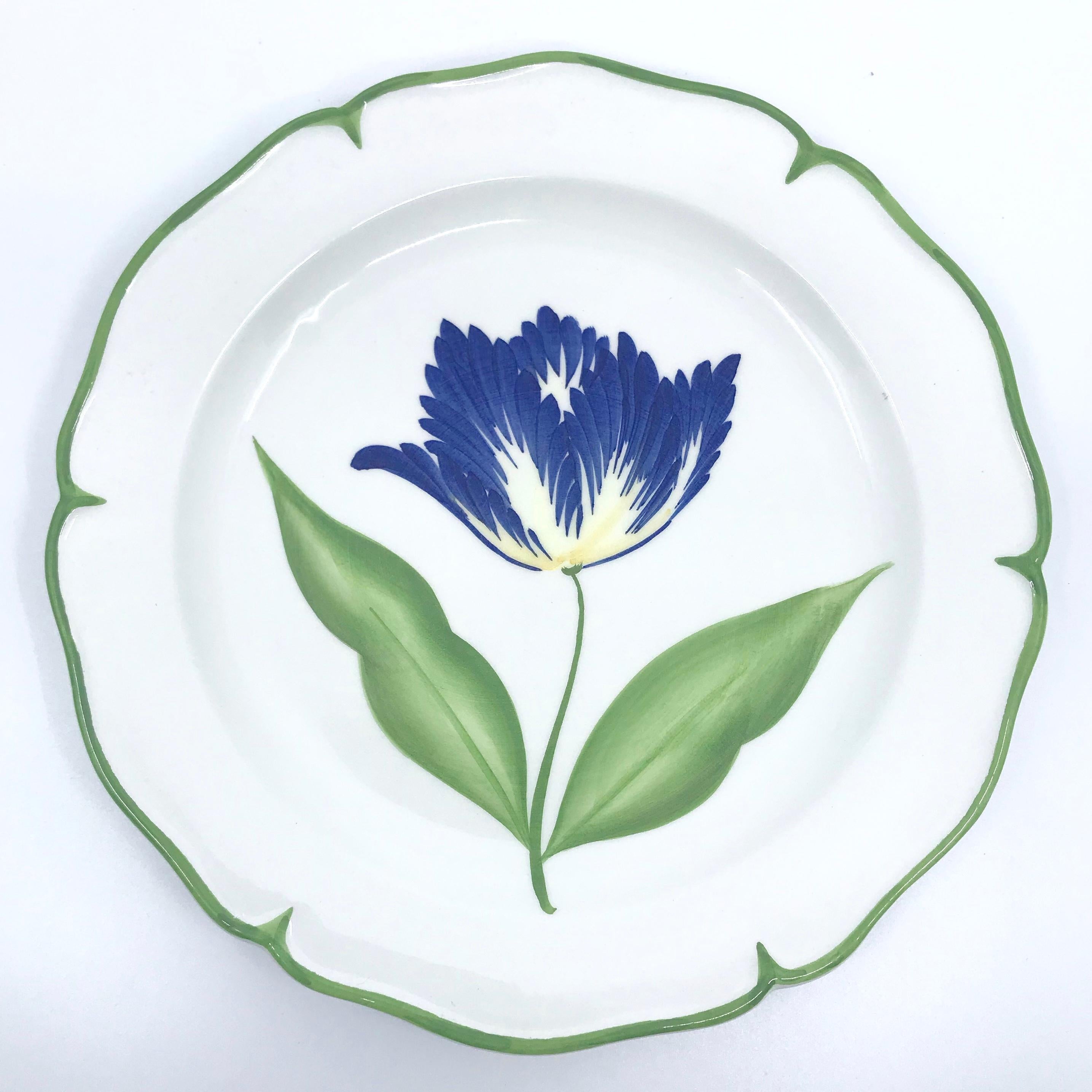 Set of four flower plates with green border. Four individually hand painted vintage pottery plates with shaped green borders featuring one of four different tulips in magenta, red, apricot and blue. Italy, 1970s.
Dimensions: 8” diameter x .88