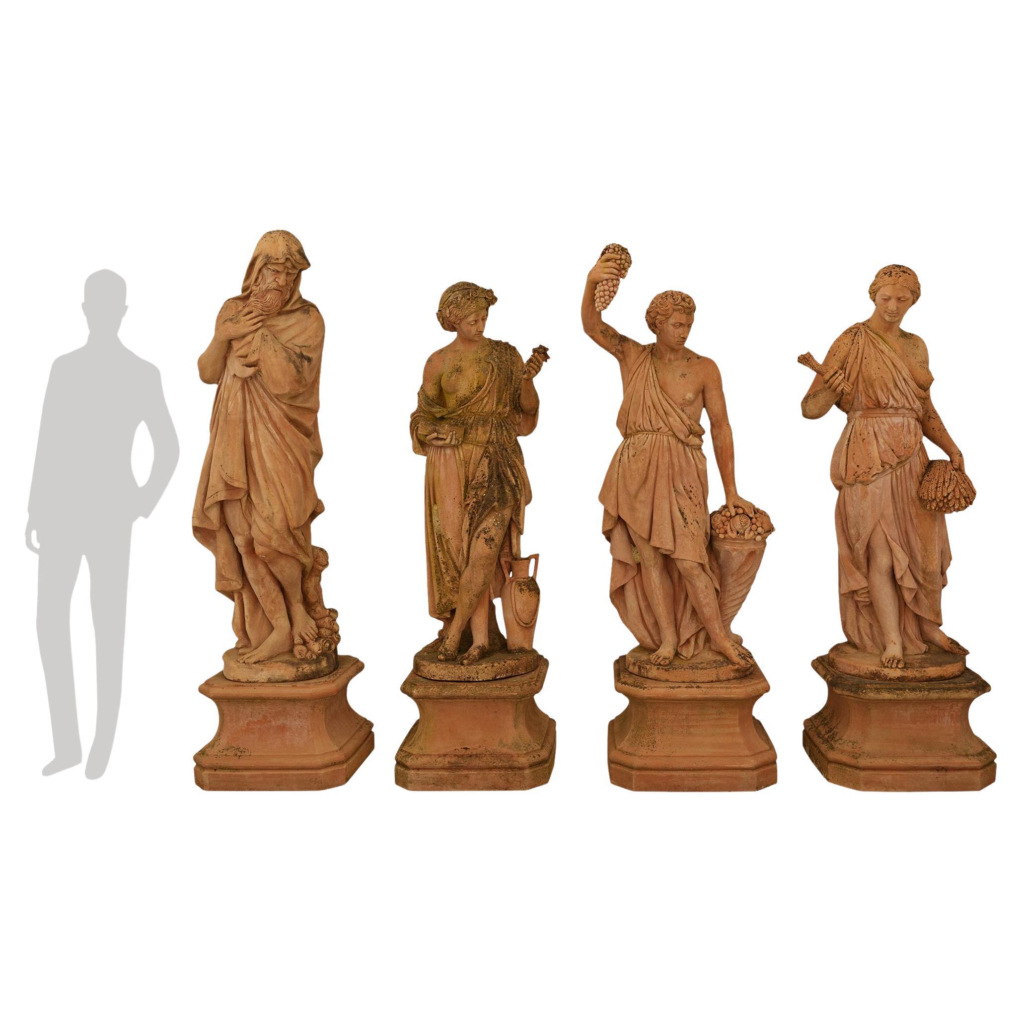 A sensational and palatially scaled set of four Italian Turn of the Century Terra Cotta statues of The Four Seasons. Each impressive statue is raised on its original square base with mottled edges and concave sides, below the display shelf with