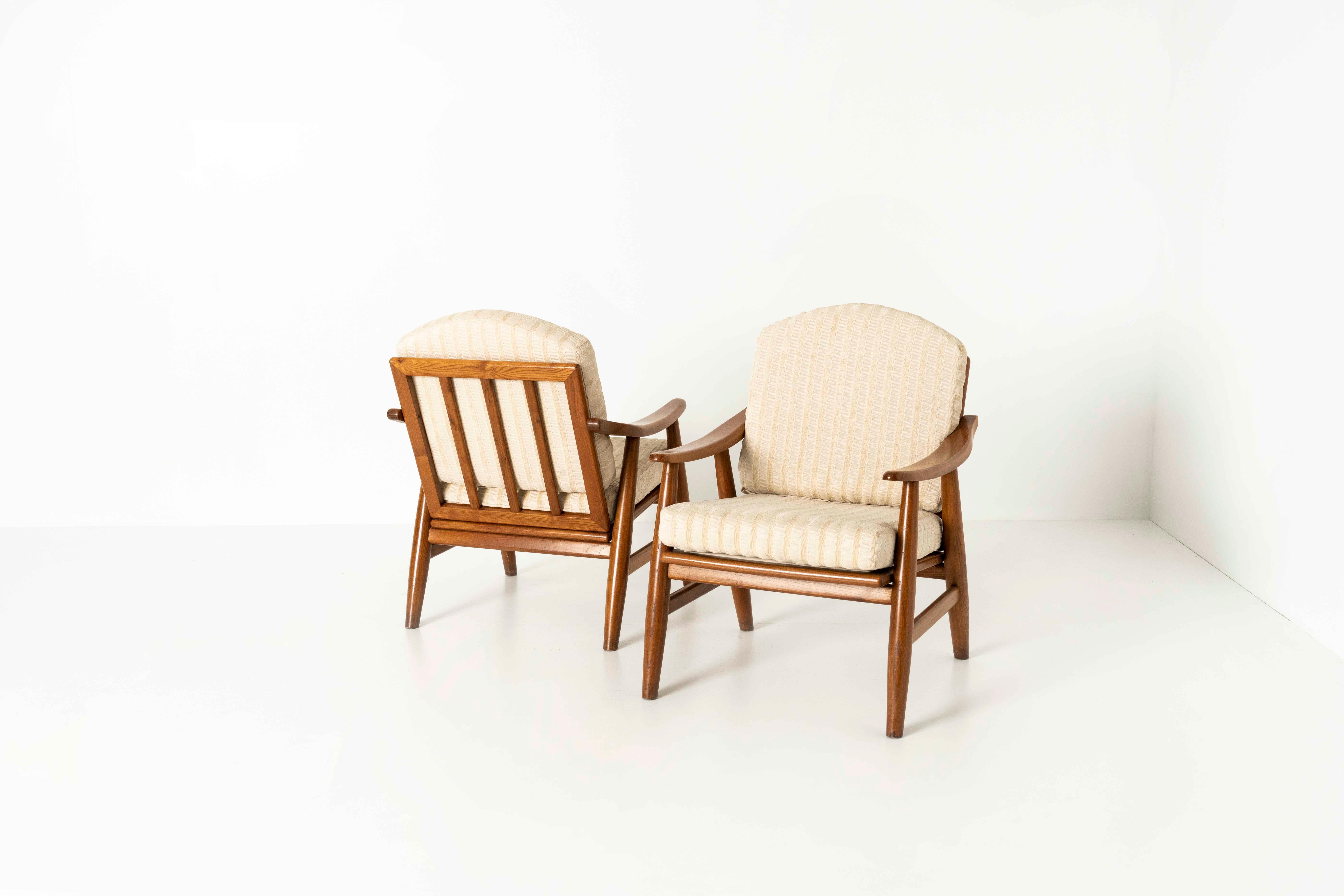 Set of Four Italian Vintage Lounge Chairs from the 1970s. These chairs have a simple, yet elegant design and two cushions in off-white shiny fabric. The legs are cone-shaped and the backrest is bent backward, making the chairs comfortable. Upon