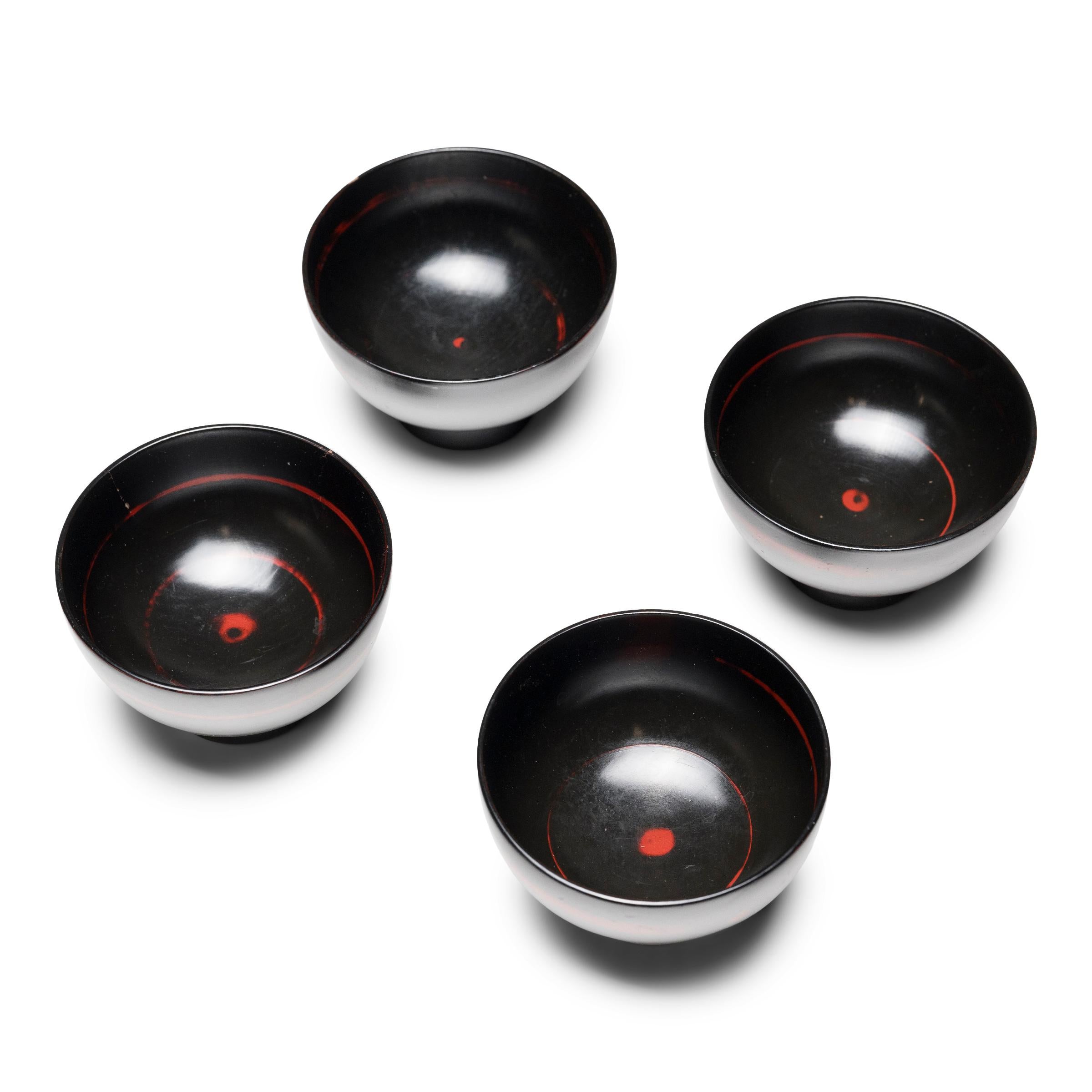 20th Century Set of Four Japanese Black Lacquer Bowls with Red Spiral