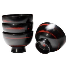 Set of Four Japanese Black Lacquer Bowls with Red Spiral