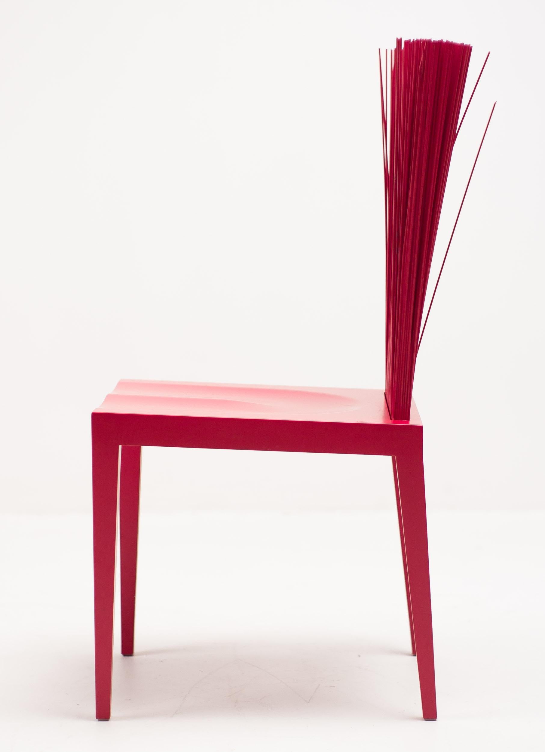 Fernando and Humberto Campana designed these Avant Garde chairs for Edra in 2005. 
The legs and seat are solid while the back is flexible, thanks to a full swath of PVC rods. 
With prolonged use, the “stalks” open and shape the back into its final