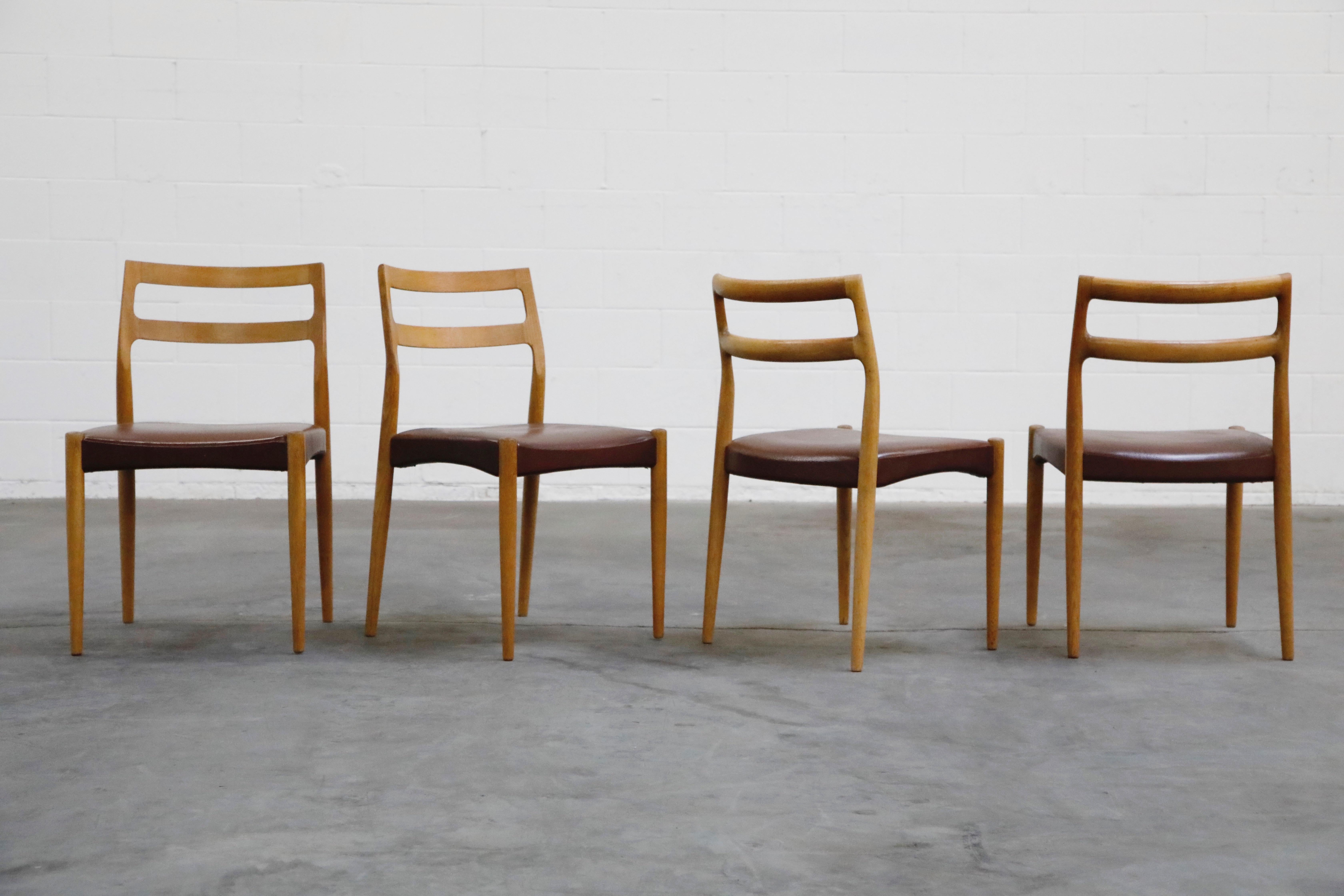 This lovely set of four (4) Danish Modern dining chairs are by Johannes Andersen for Uldum Møbelfabrik, sculpted from oak with leatherette upholstery, and in the style of Niels Otto Moller, these are a perfect option for interior designers and
