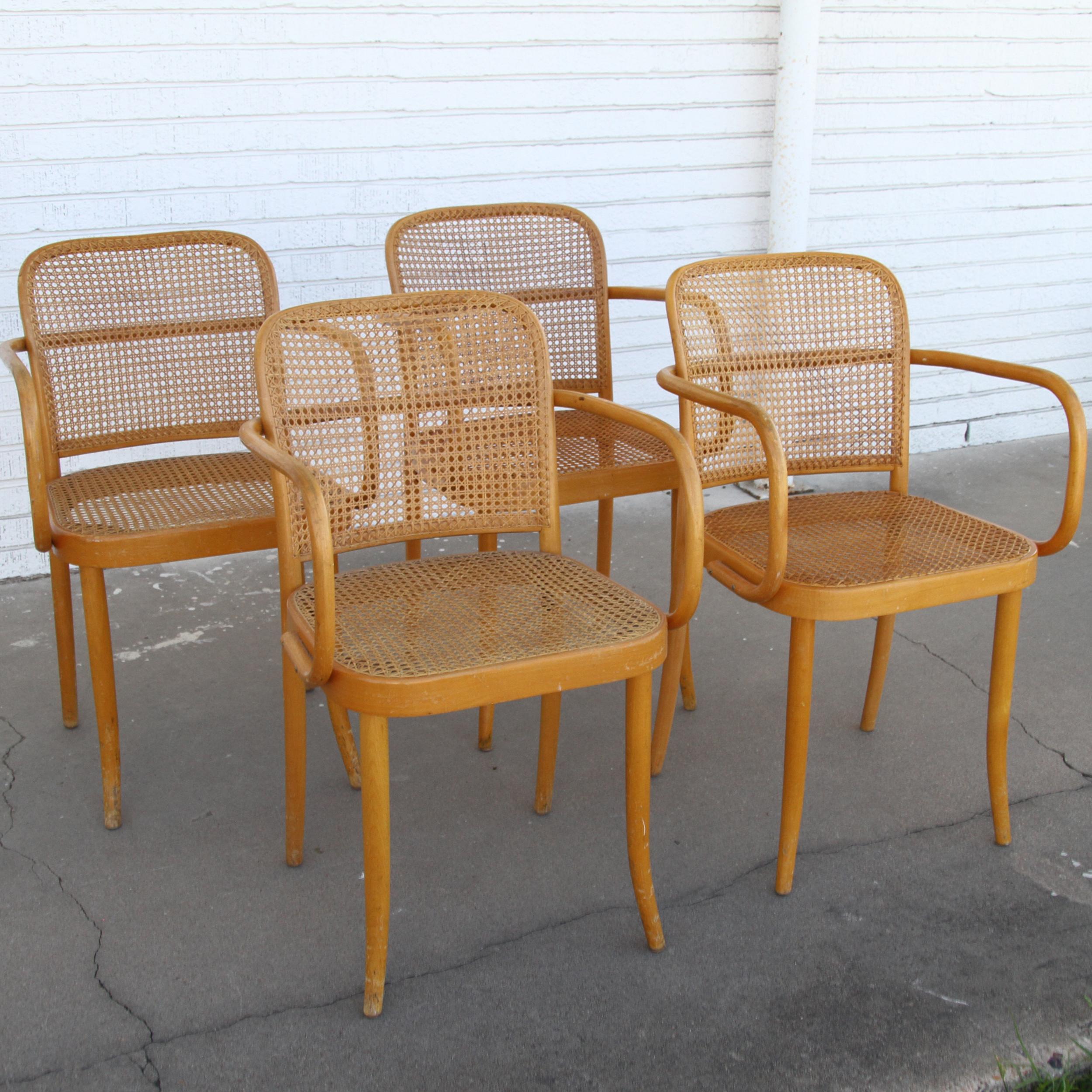 Mid-Century Modern set of four bentwood beech armchairs designed by Austrian architects Josef Frank and Josef Hoffman for Thonet. Each chair stamped made in Poland. The chairs feature cane inset seat and backs. Known as Prague chairs model 811 the