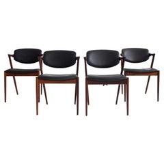 Set of Four Kai Kristiansen Model 42 Black Leather and Hardwood Chairs