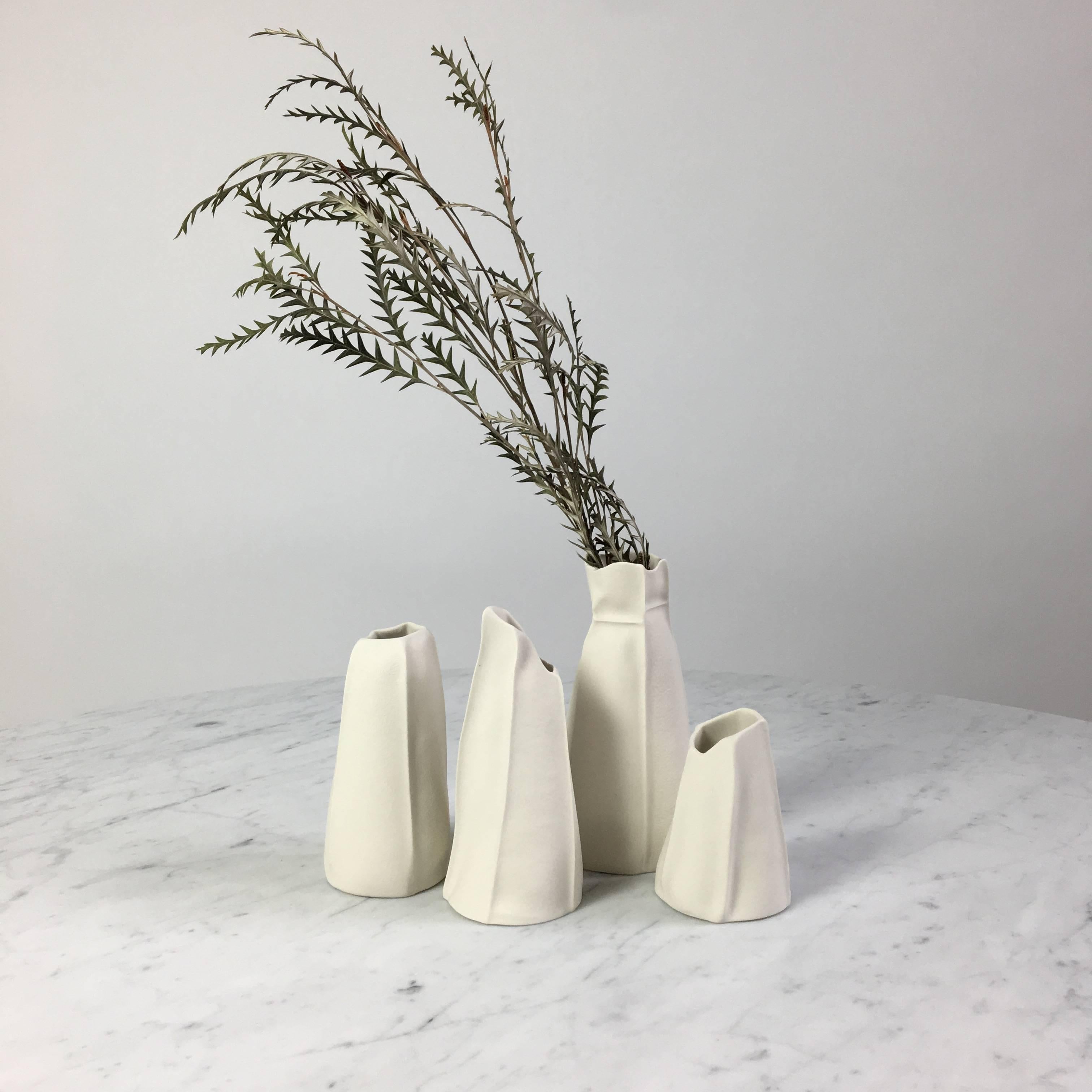 This listing is for a set of four unusual vases from the Kawa Porcelain series designed/made by Souda's Co-Owner, Luft Tanaka. Each piece has been made by casting liquid porcelain into a molds made entirely of leather. This highly-unique casting