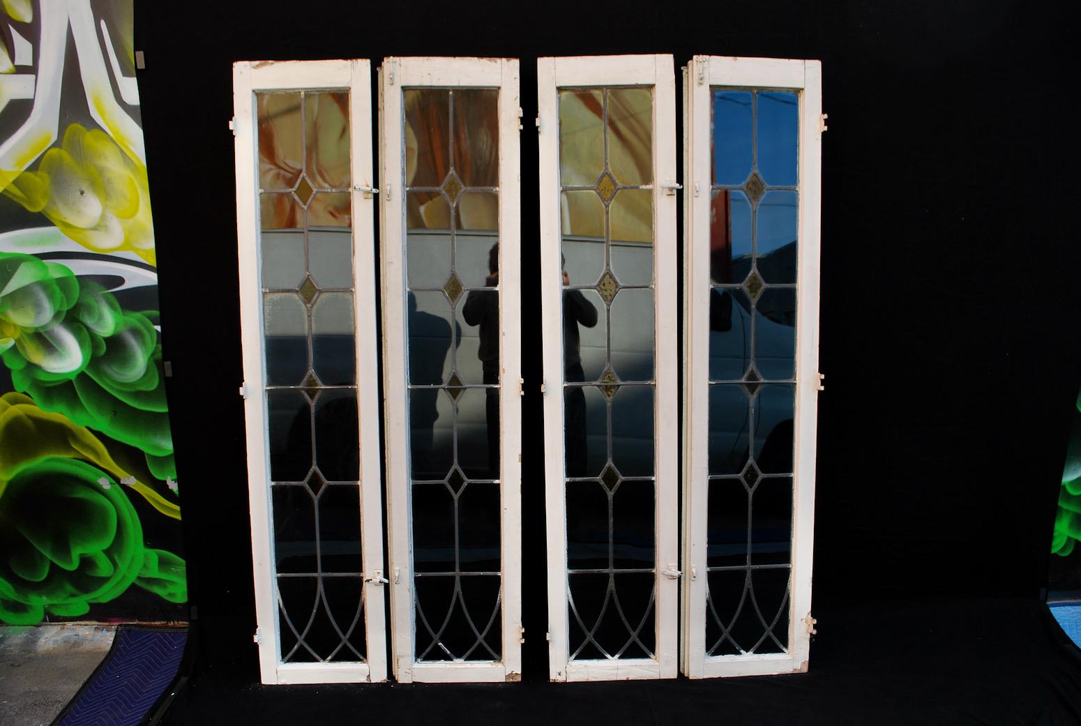 A set of 4 large 1920s windows, we can sell them by pair, please look at all the pictures, they need some restoration, they are still in good shape considerate they have been outside for 100 years.