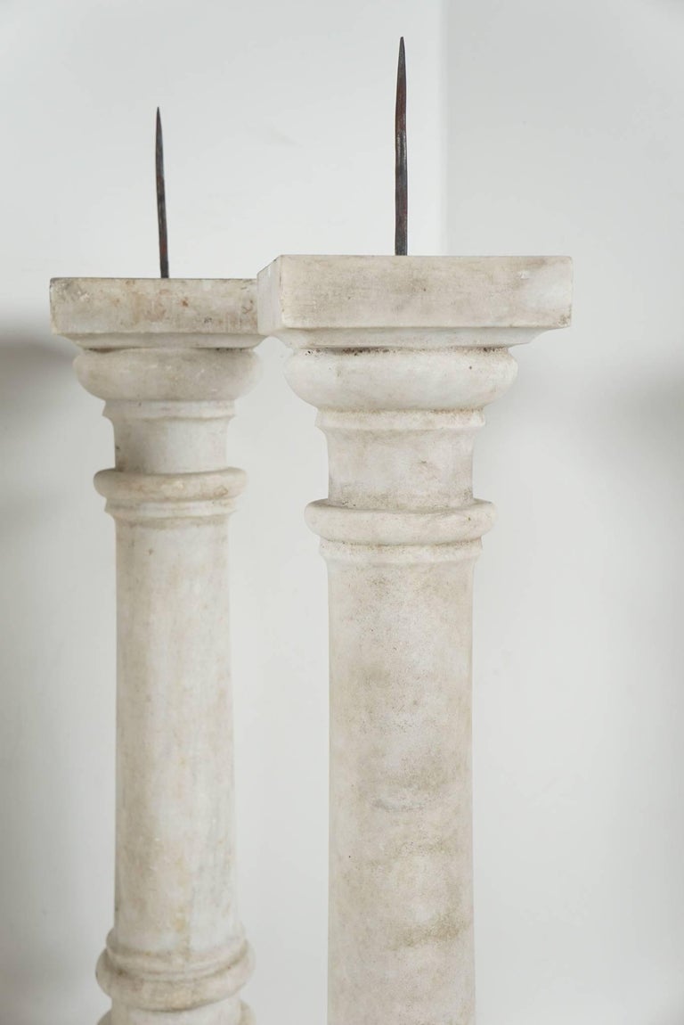 This set of carved marble pricket candlesticks might have been used as altar sticks for a church but could easily also have been made for a private house that had marble details and devices so that these would accompany the interior. Made from white