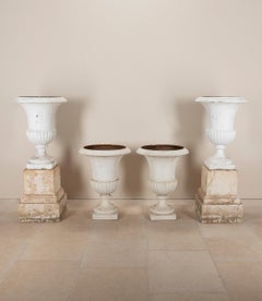 Set of Four Large 19th Century Painted Cast Iron Urns with a Pair of Cast Iron P