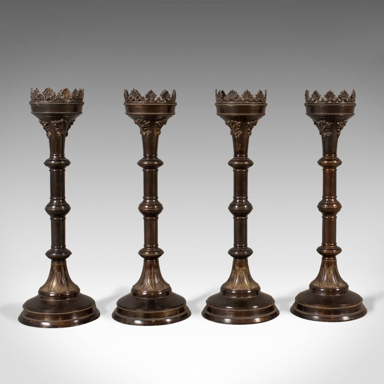 This is a bold set of four large candlesticks, church candle pricket torcheres in the Victorian taste with Gothic overtones.

Candlesticks for large four inch church candles
Offering a stable and solid mount with pricket cradles
Bronzed,