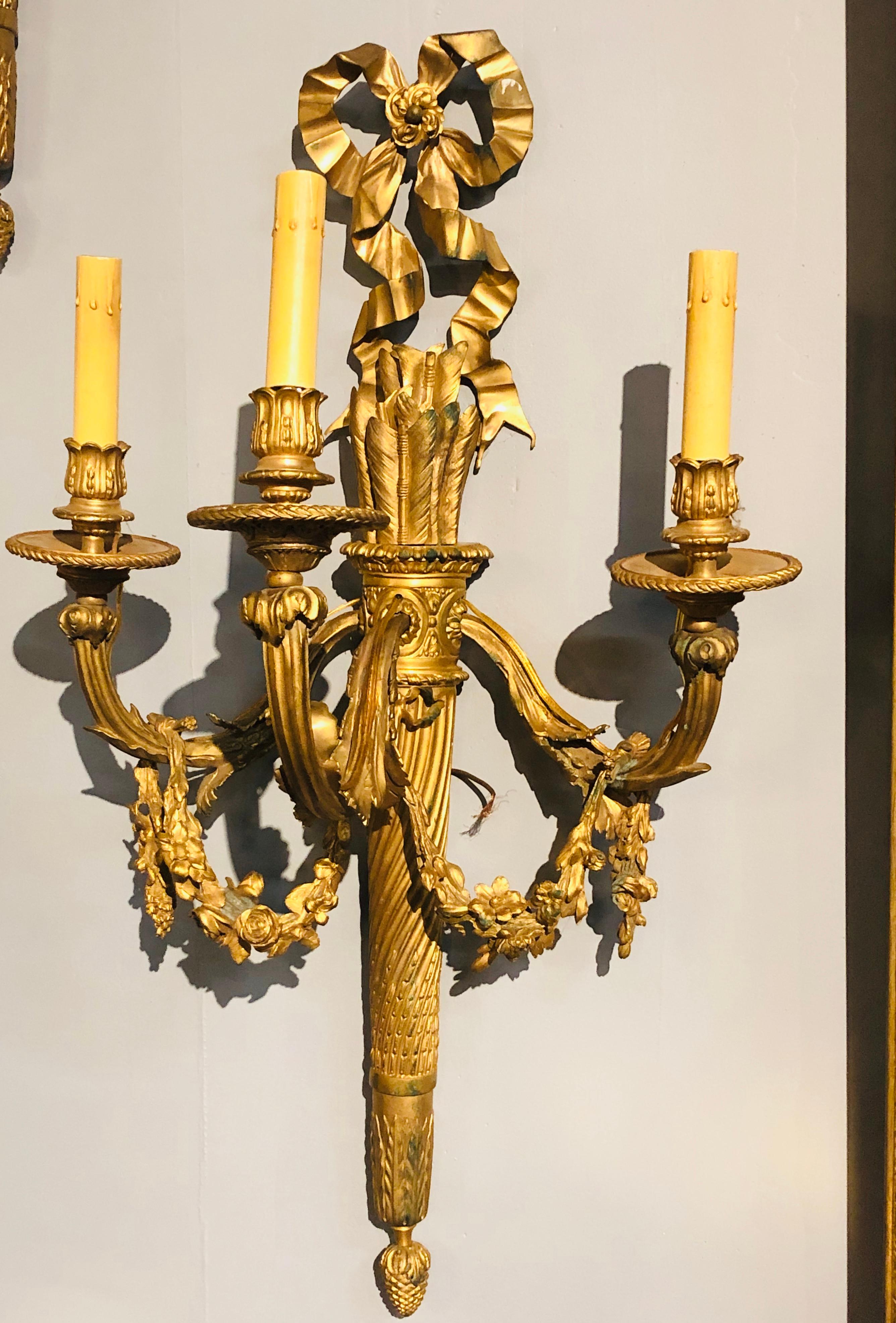 Set of Four Large Ornate Three-Light Torch and Ribbon Form Wall Sconces In Good Condition In Stamford, CT