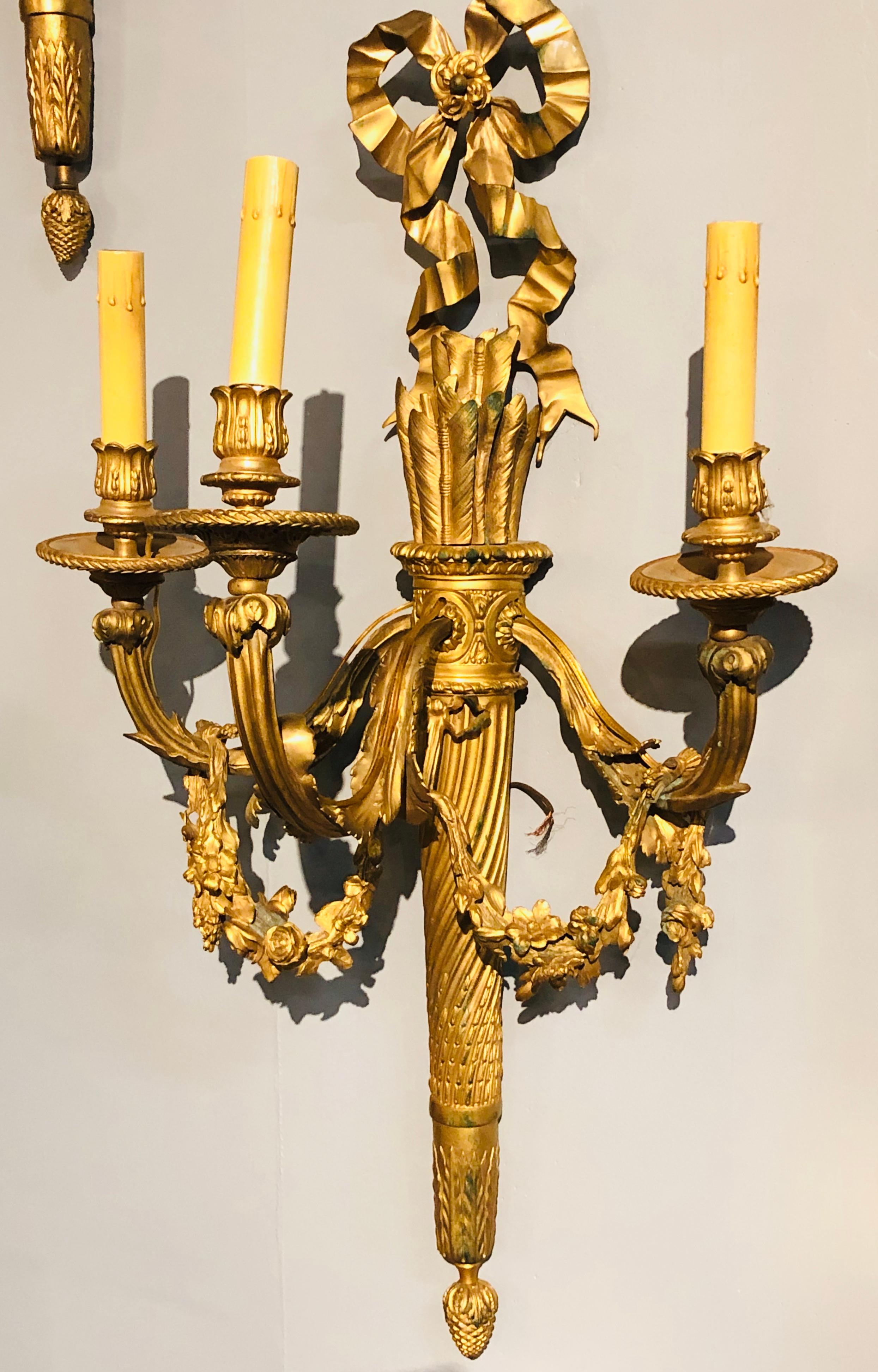 20th Century Set of Four Large Ornate Three-Light Torch and Ribbon Form Wall Sconces