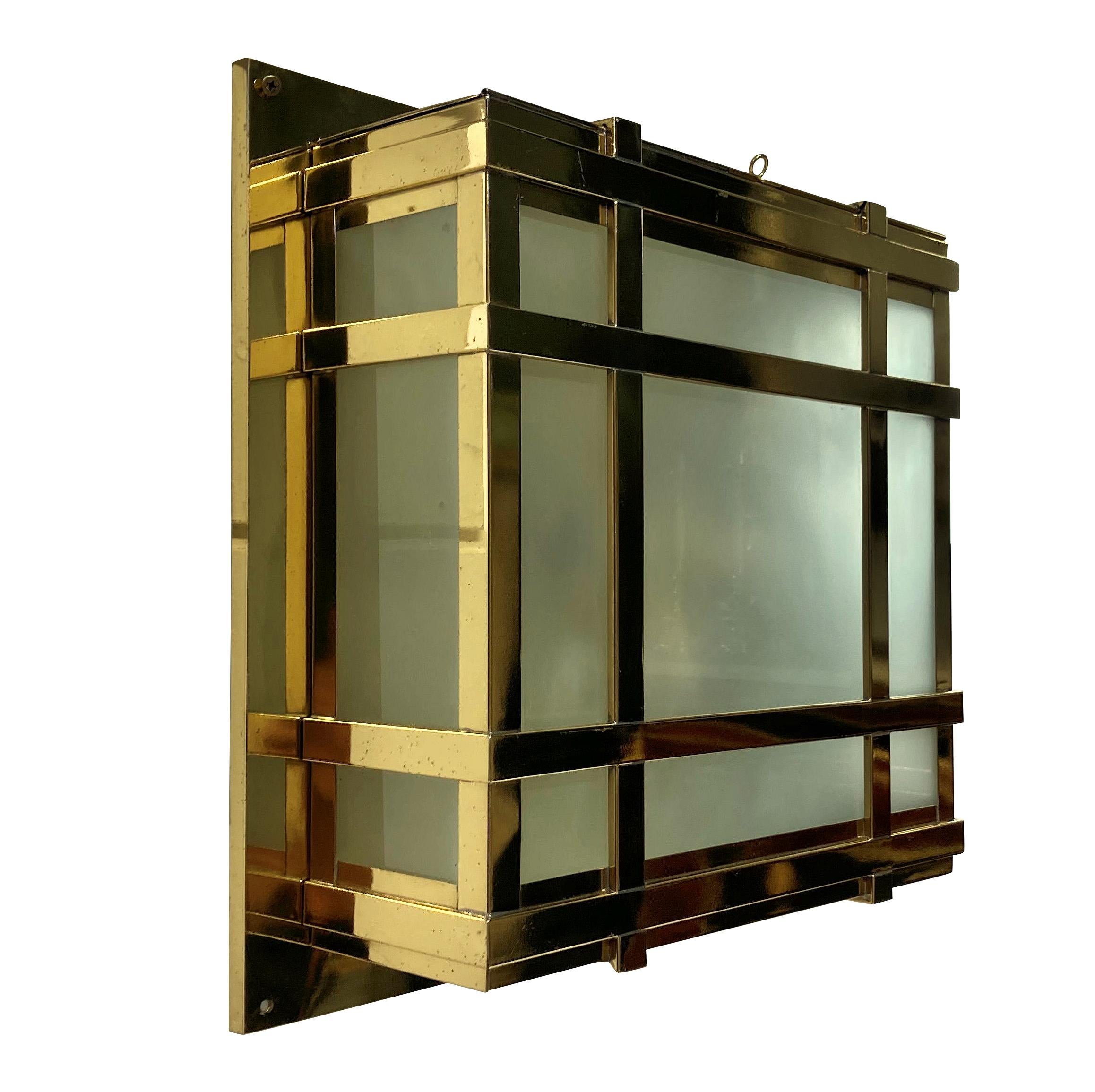 A set of four large American Modernist wall lights in lacquered brass, with opaque glass panels. Each with a door and provision for four lights inside each.