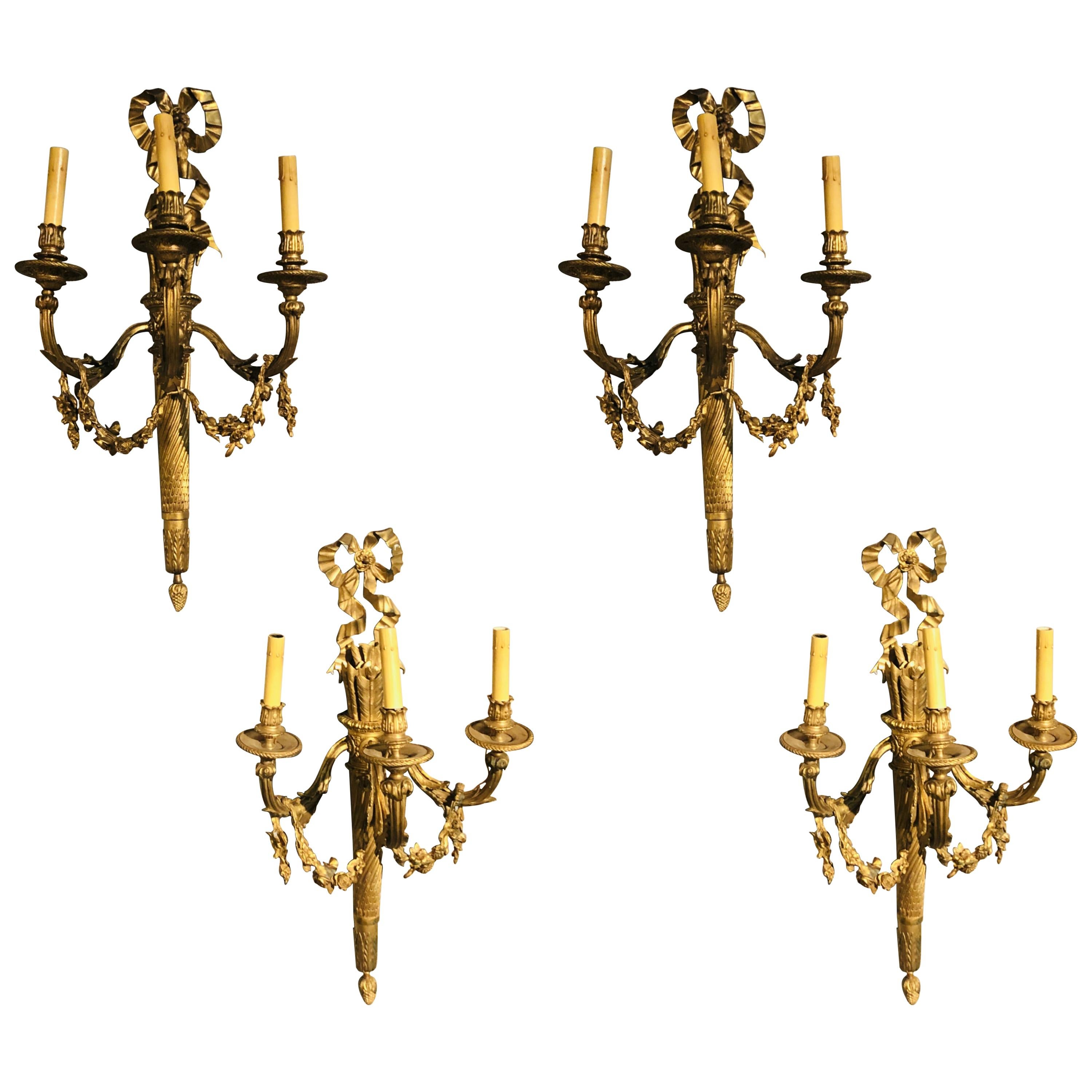 Set of Four Large Ornate Three-Light Torch and Ribbon Form Wall Sconces