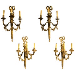 Set of Four Large Ornate Three-Light Torch and Ribbon Form Wall Sconces