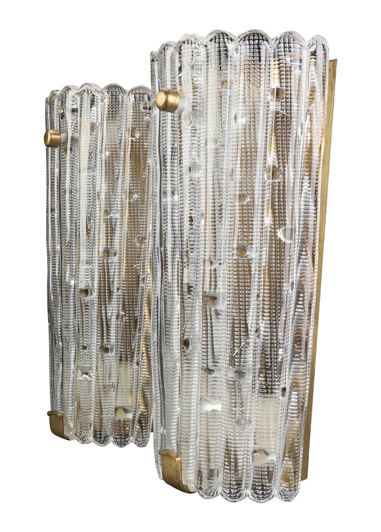 Large Orrefors wall sconces designed by Carl Fagerlund for lighting company Lyfa, Sweden. There are three available each one with stunning textured, ridged and scalloped Orrefors glass panels on a brass back plate with 3-light fitting.

