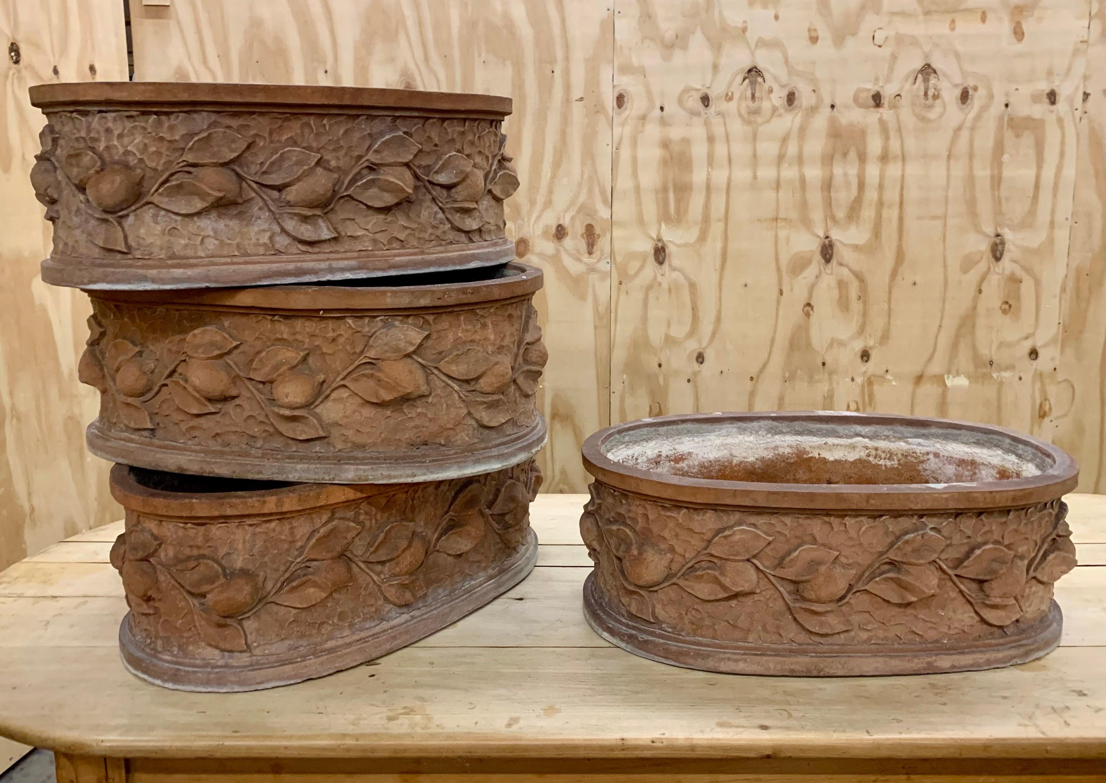 Wonderful and rare set of four vintage oval terracotta jardinieres with the mos lovely patina. Perfect for the garden or orangery. The jardinieres has a hand carved relief of lemon branches and all four are in very good shape.