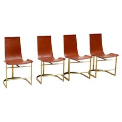 Set of four leather and brass Italian dining chairs